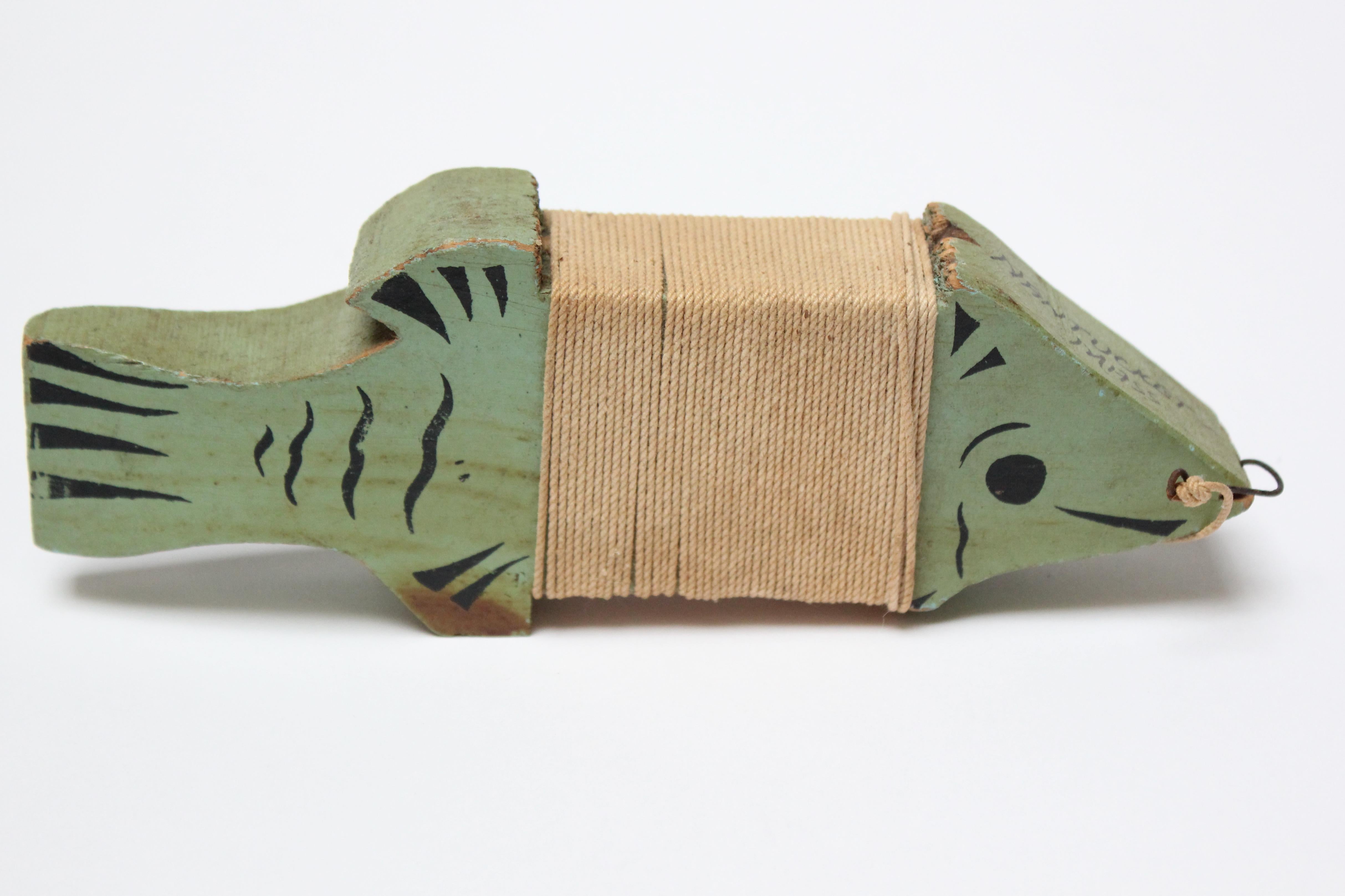 Hand carved and painted mint green fish souvenir spool from Nantucket Island (ca. 1940s, MA, USA). The fishing twine is connected to a small metal hook affixed to the fish's mouth. Warm patina / good age commensurate with history (small spots of