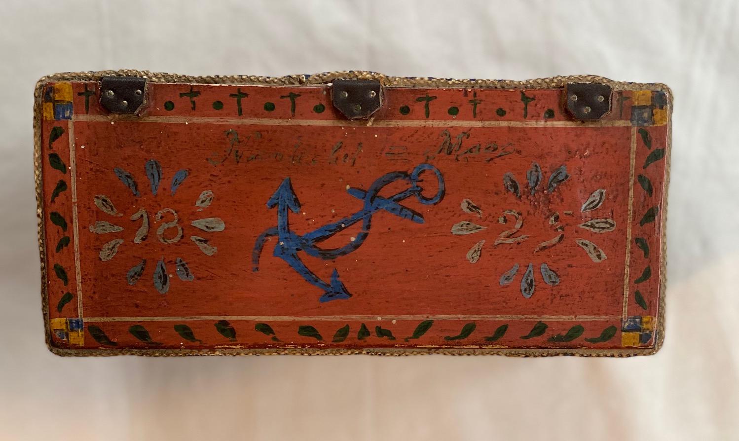 Folk Art Nantucket miniature decorated sea chest, likely circa 1940s or earlier, a classic six board chest with canted front, carved wooden beckets with rope handles, lid has edge braces and is attached via three leather hinges, there is painted