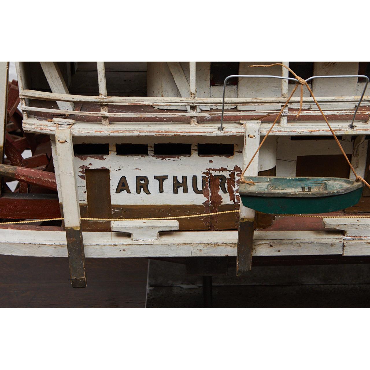 This Folk Art paddleboat from the 1920s has incredible articulated details throughout. The boat is named “Arthur” and hails from Paducah, KY. The paddle turns, the top deck has fabric sacks of grain and bails of cotton, the buoys are moveable, and