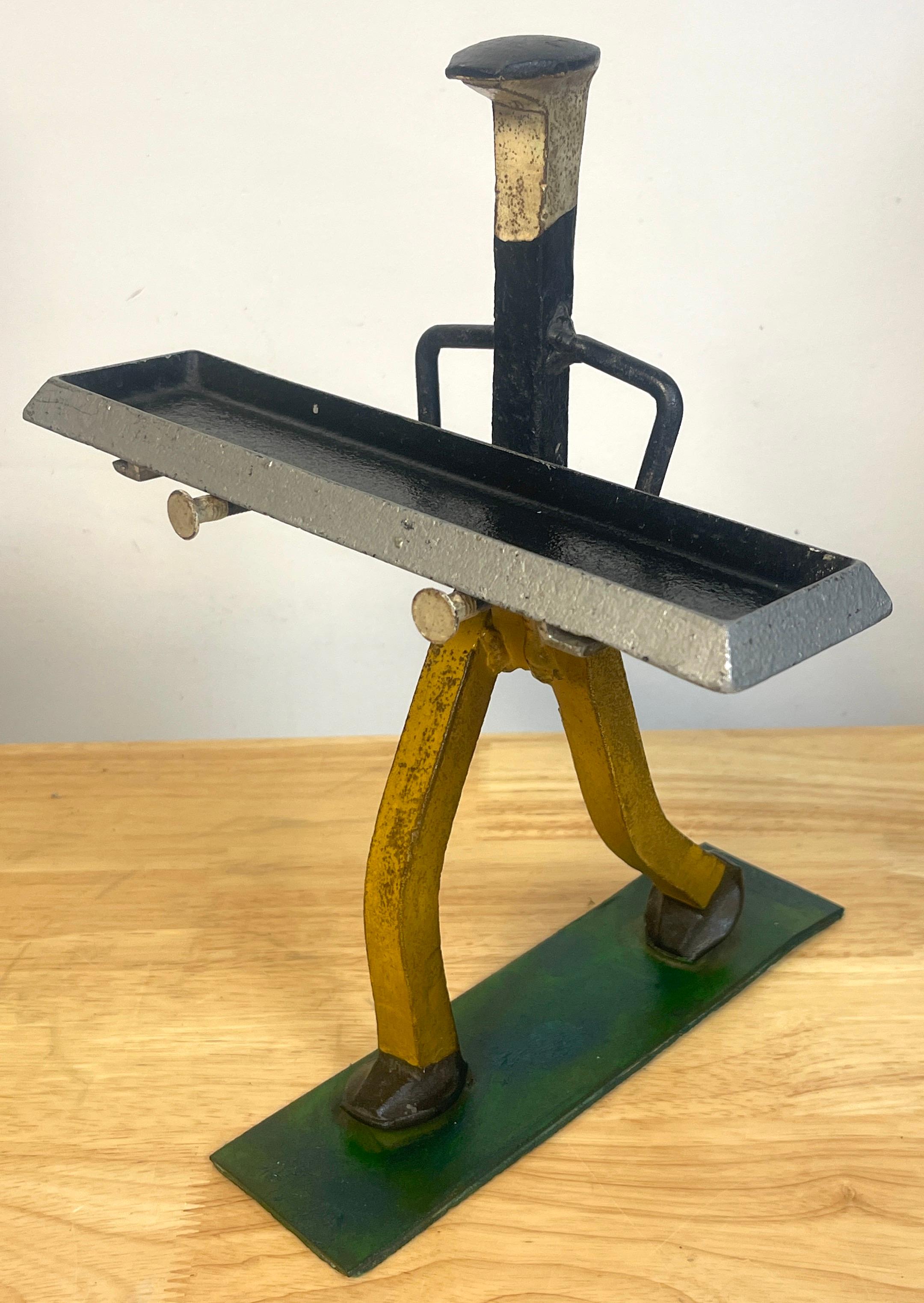 Folk Art polychromed iron construction worker card holder/ vide-poche
A whimsical well executed Folk Art sculpture of construction worker caring a beam ( removable tray) on a grassy field. Made of polychromed Railroad tie, Nails, Iron and Aluminum.