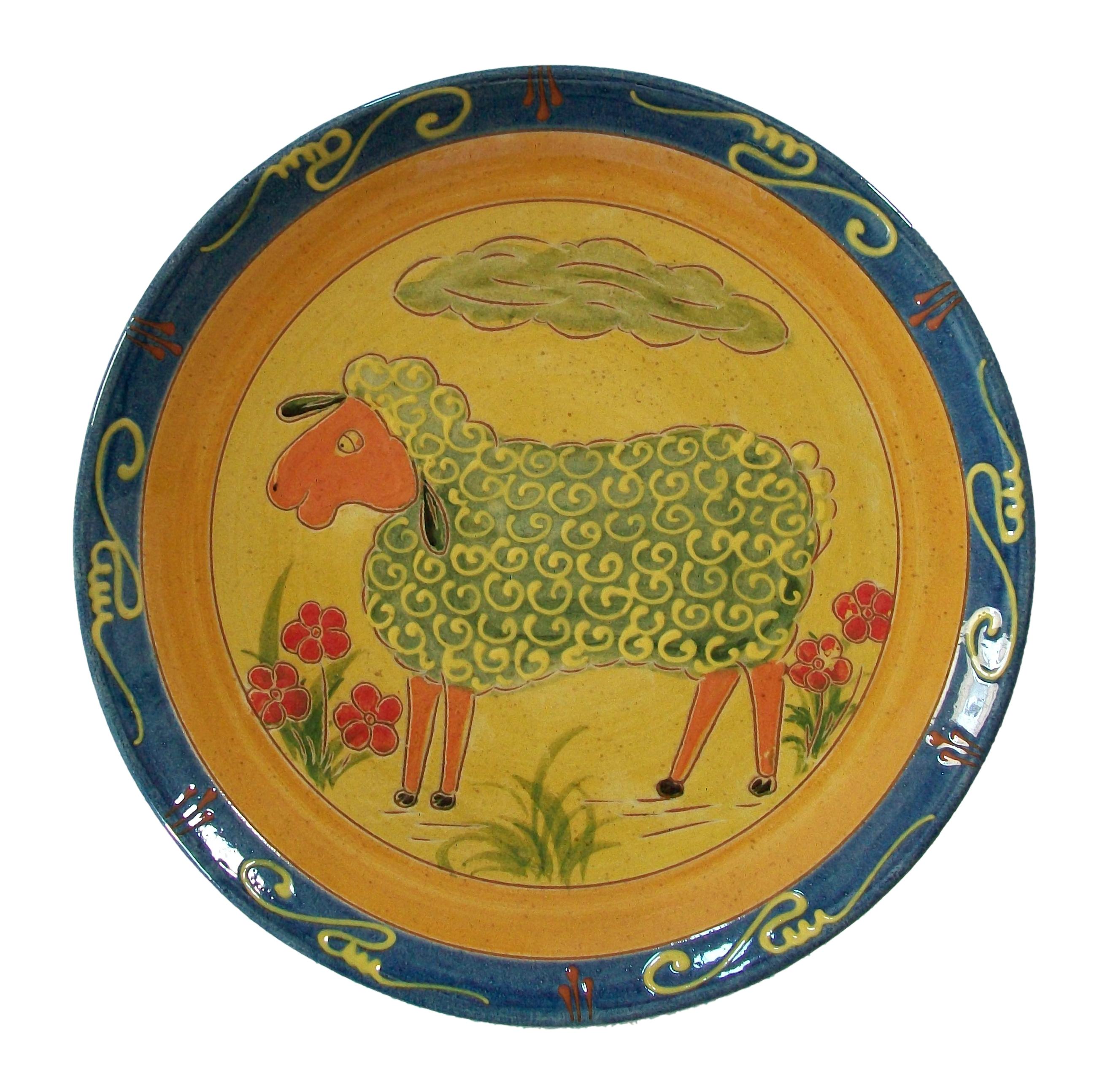 M. MIXA?HE - Vintage folk art pottery charger or wall plate - large size - hand made and hand painted and incised with a sheep and flowers - applied slip decorative scrolls to the banded border - stylized leafy grass sprays to the back border -
