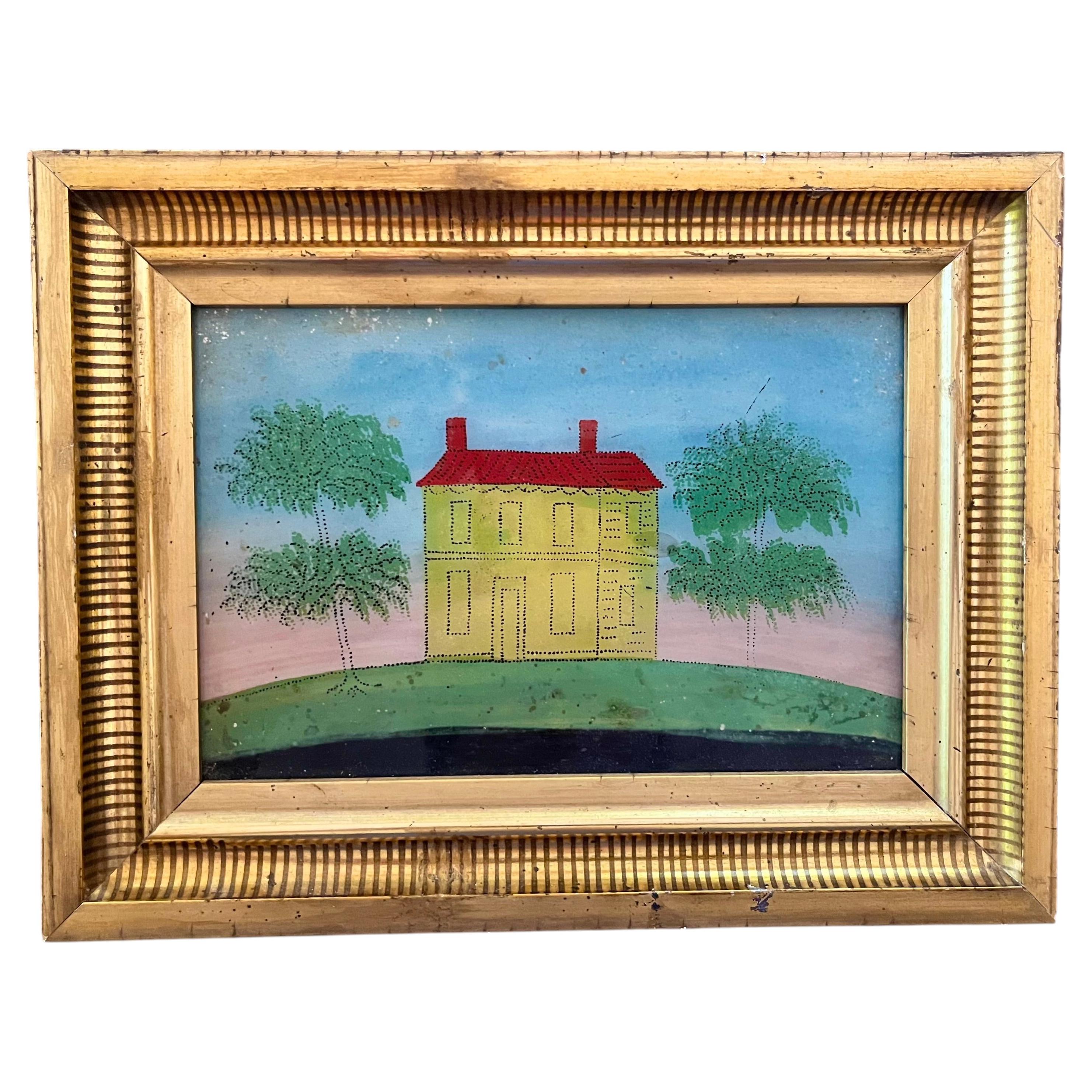 Pintura primitiva de arte popular en vidrio con técnica de eglomisé y pintura al revés de una casa de estilo federal