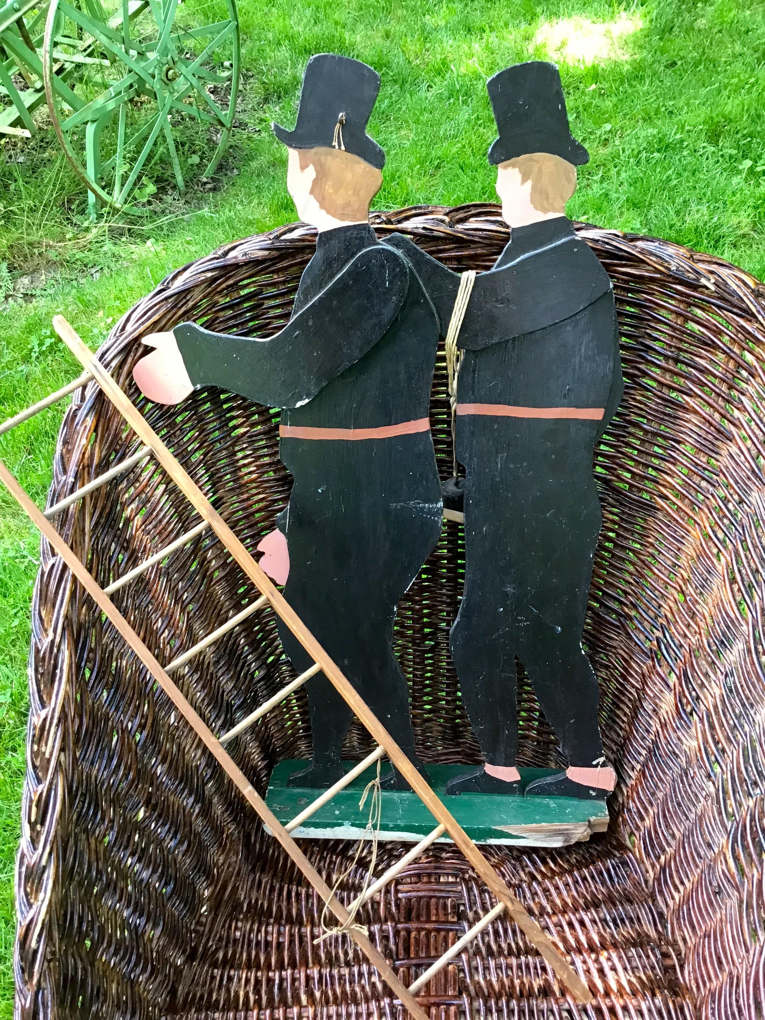 This whimsical folk art sculpture is a folk art toy of chimney sweeps. The outsider art is hand painted on wood cutouts. A wonderful hand made, hand painted piece of folk art, outsider art, and a primitive toy. 
The arms are not moveable on this