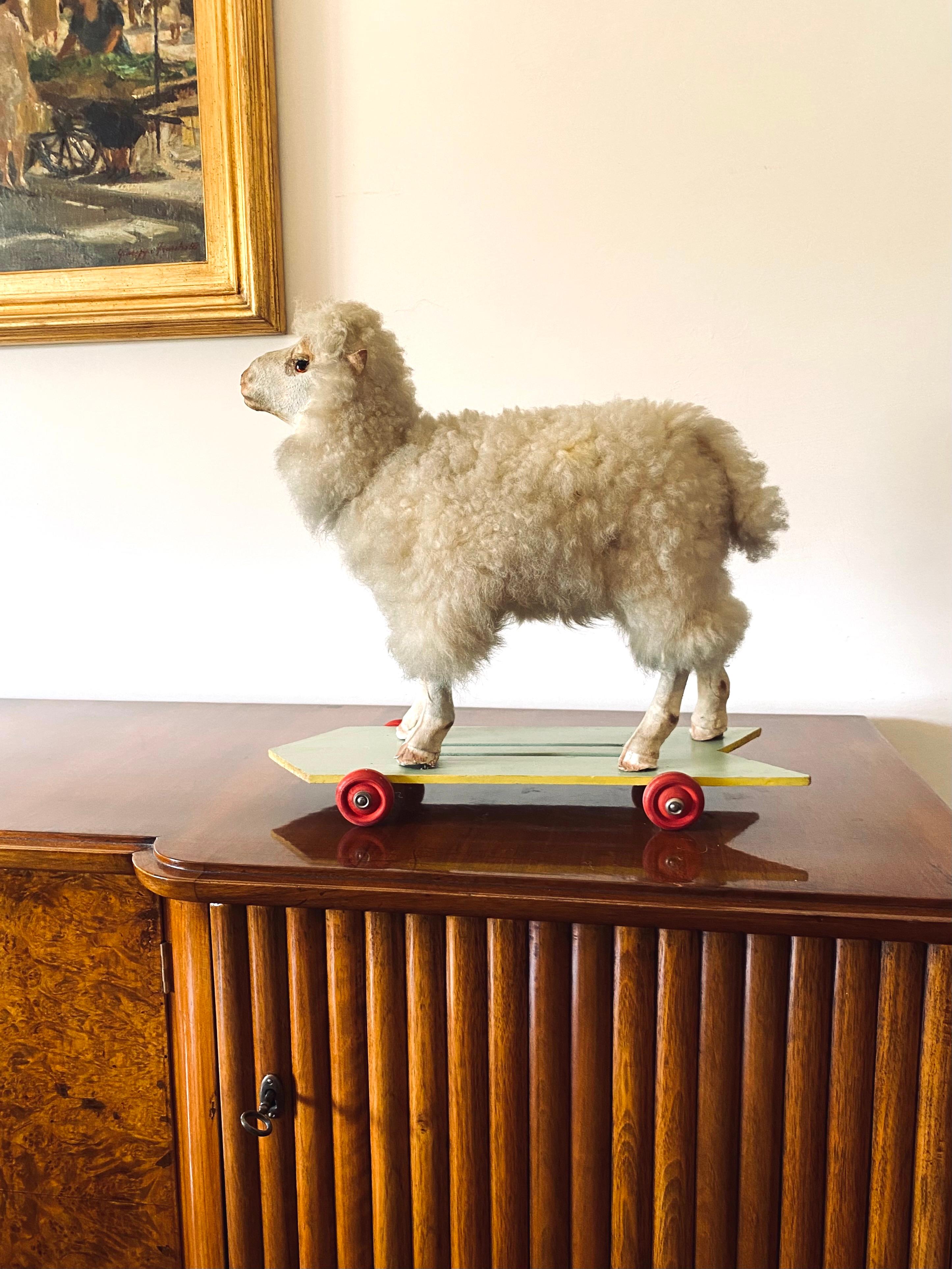 Folk Art sheep rolling toy

Germany, first half of 20th century

wool, wood, fabric

Bending the neck the sheep bleats. 

High craftsmanship.

H 40 cm - 46 x 18 cm

Conditions: good consistent with age and use. The photos are considered
