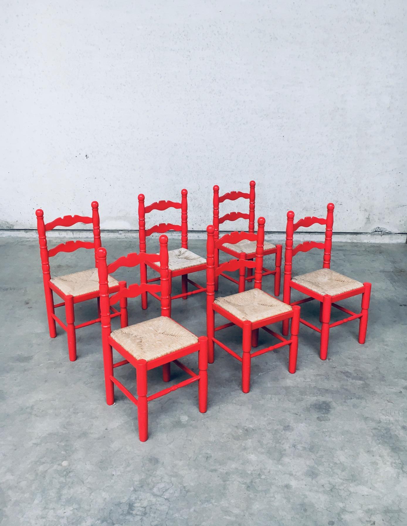 Folk Art Style Design Red Dining Chairs by Vanderree / Berkel. Made in the Netherlands, 1970's period. As in a 1973 dutch Catalog for furniture models for that year. Set of 6 chairs. Red stained beech wood frame with woven rush seats. Turned wooden