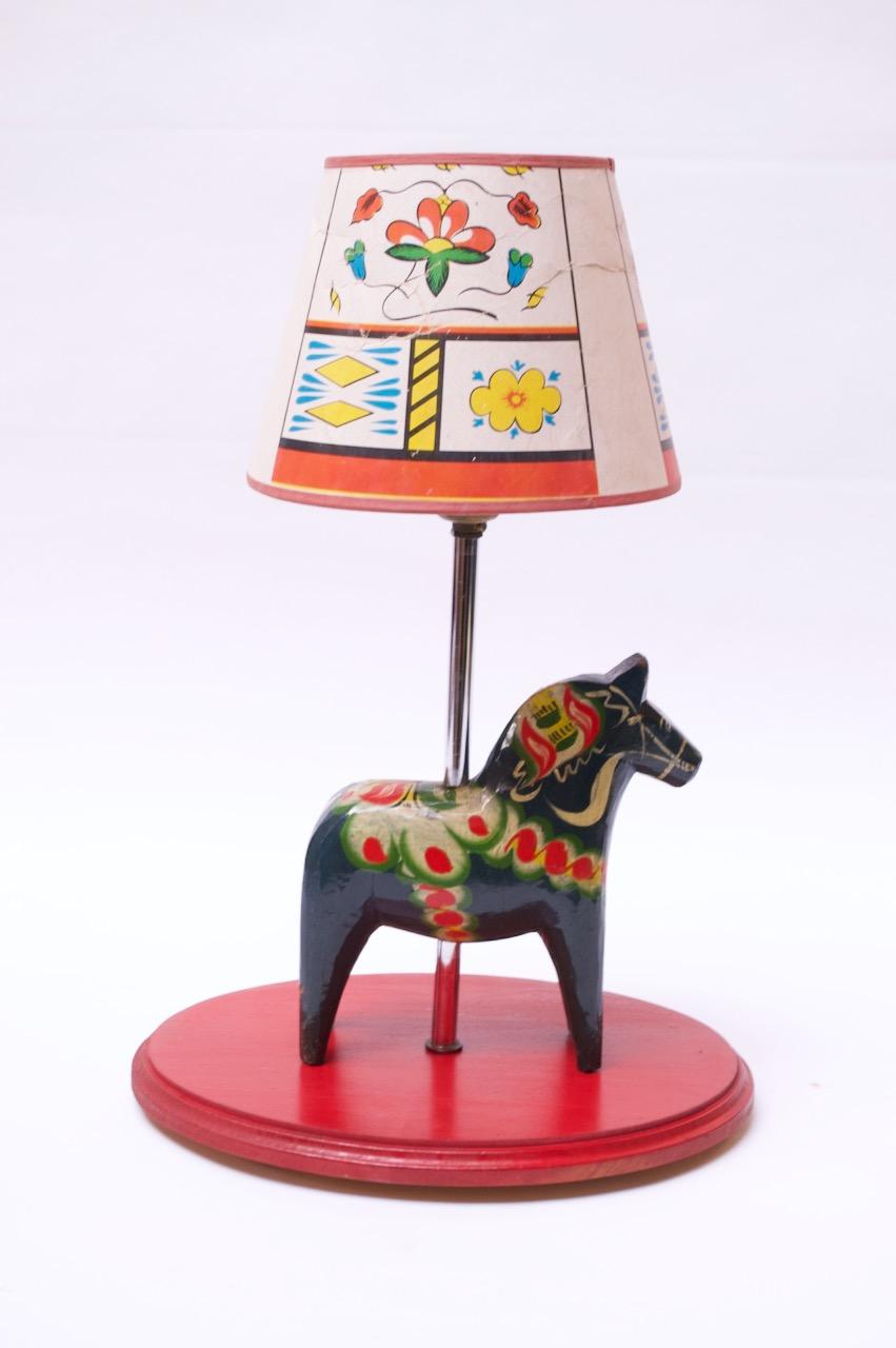 Unique, hand-assembled Dala horse lamp (horse, designed by Nils Olsson, dates to circa 1960, Sweden; the lamp was likely assembled in the 1970s-1980s, USA). The blue-green Dala horse measuring L: 8