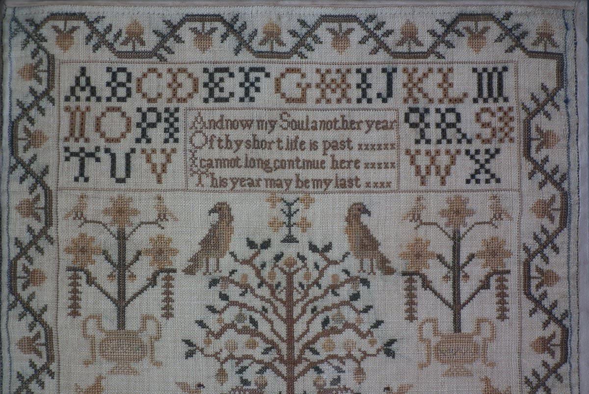 Antique Sampler, circa 1830, by Harriet Pellen. The sampler is worked in silk on linen ground, in cross stitch and Algerian eye. Meandering strawberry border. Colours browns, yellow, greens and cream. Alphabets A-Z in upper case and family initials
