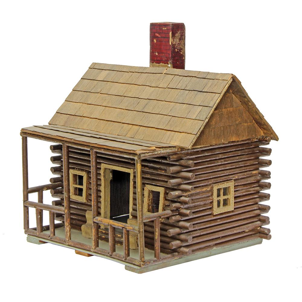 This little dollhouse has all the charm of a toy crafted at home with a skilled hand. Early 20th century Americana could not be more a part of this diminutive log cabin with its interior wallpaper and attention to architectural detail. A great piece