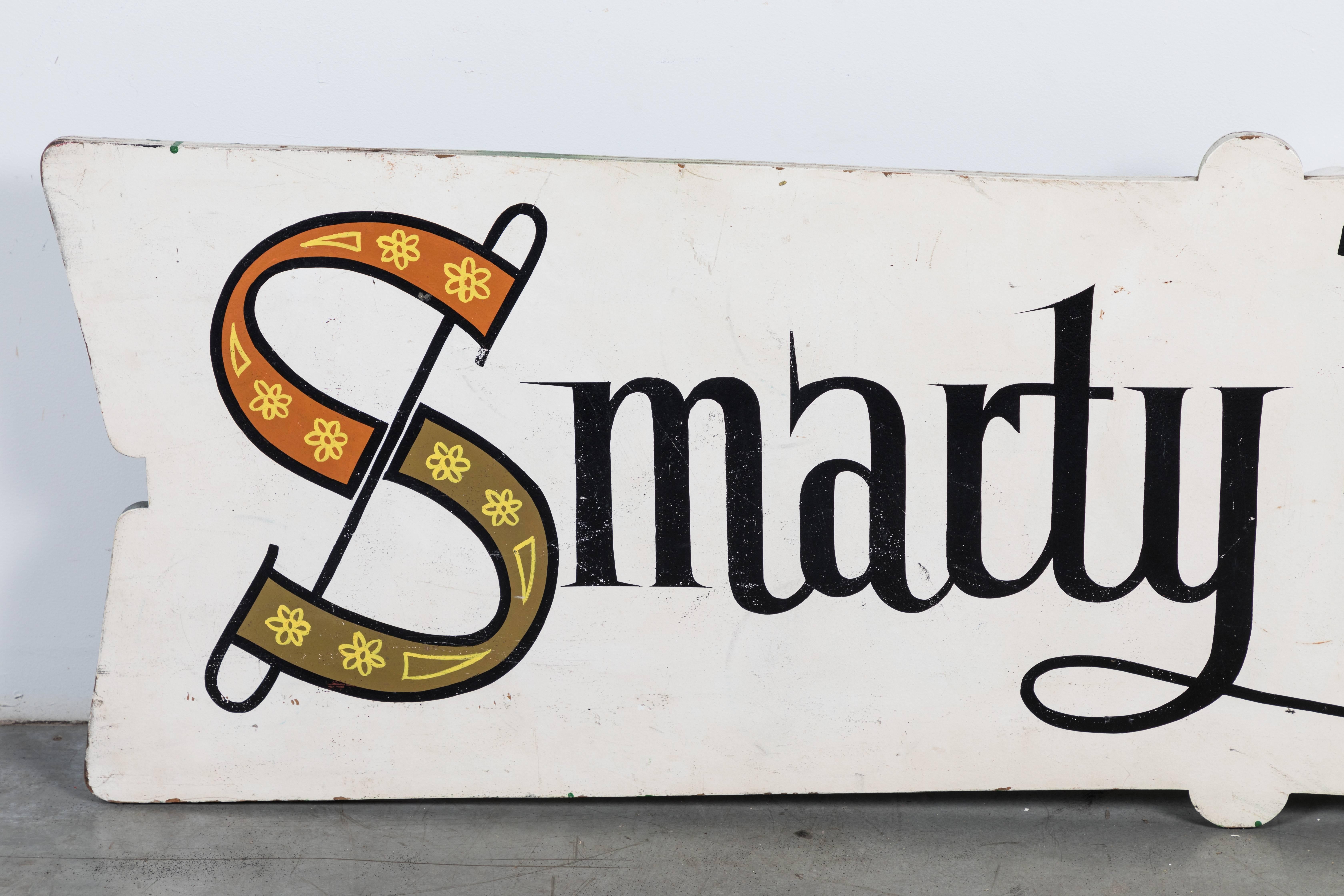 Smarty Pants For Her! Midcentury American Folk Art trade sign from a dress shop. Measures 5 feet 6 inches long by 1 foot 8 inches wide. 