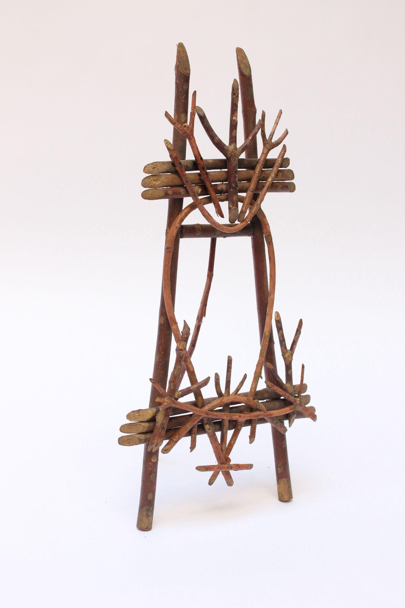 Tabletop easel composed of tree branches nailed together (ca. Mid-20th century, USA).
Wonderful American Folk Art craft in the Adirondack / Rustic style. 
There is a slim branch on the back attached to a dense cylindrical log that supports the