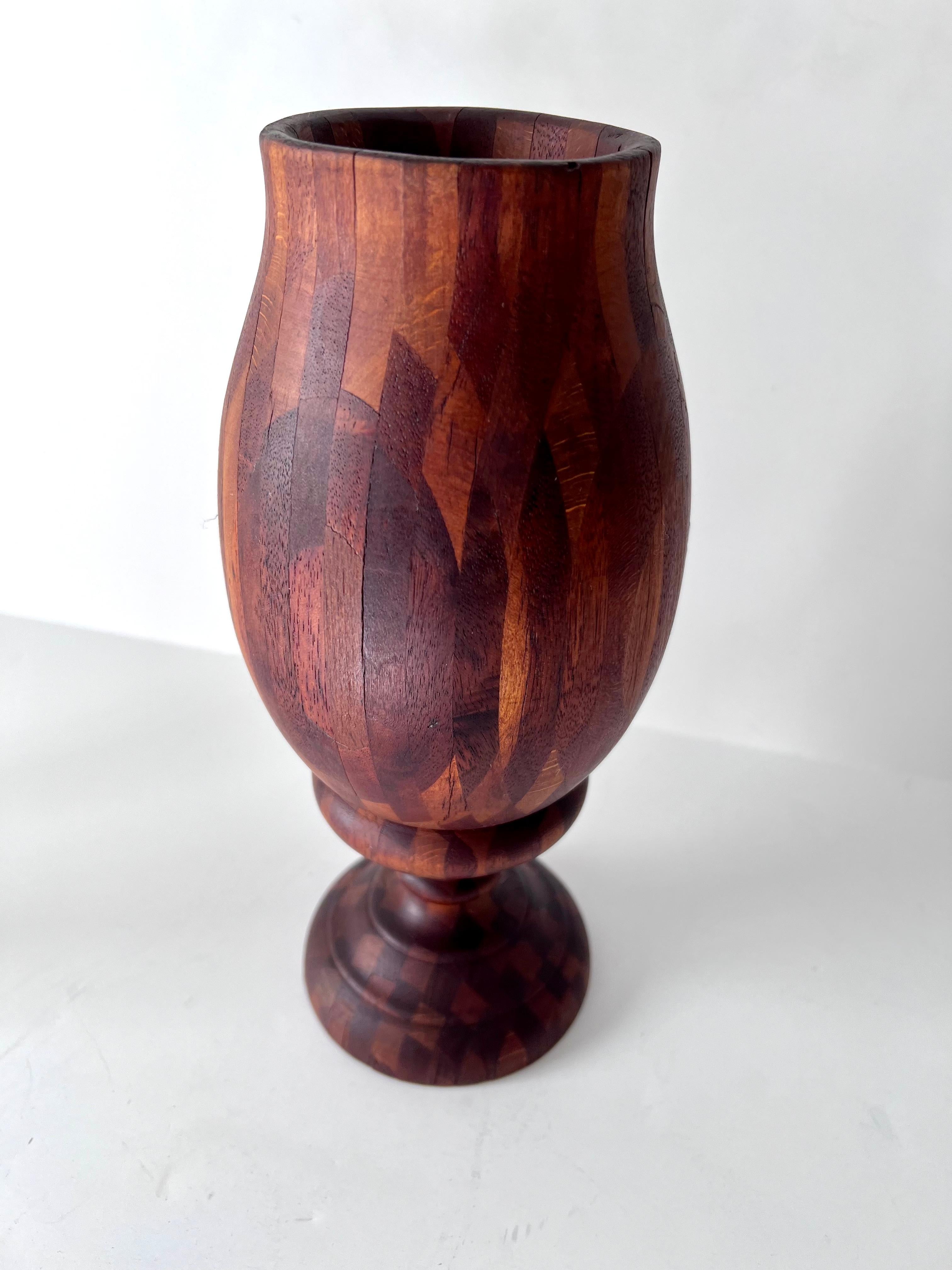 A wonderfully hand-crafted greenware vase or urn - the inlay and marquetry is wonderfully intricate and detailed.  With a little glass insert, a small tumbler, the piece could hold flowers, or would be nice to hold desk or kitchen supplies - or