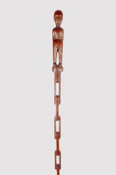 Folk art walking stick depicting a man on a chain-shaped shaft, USA 1880s.