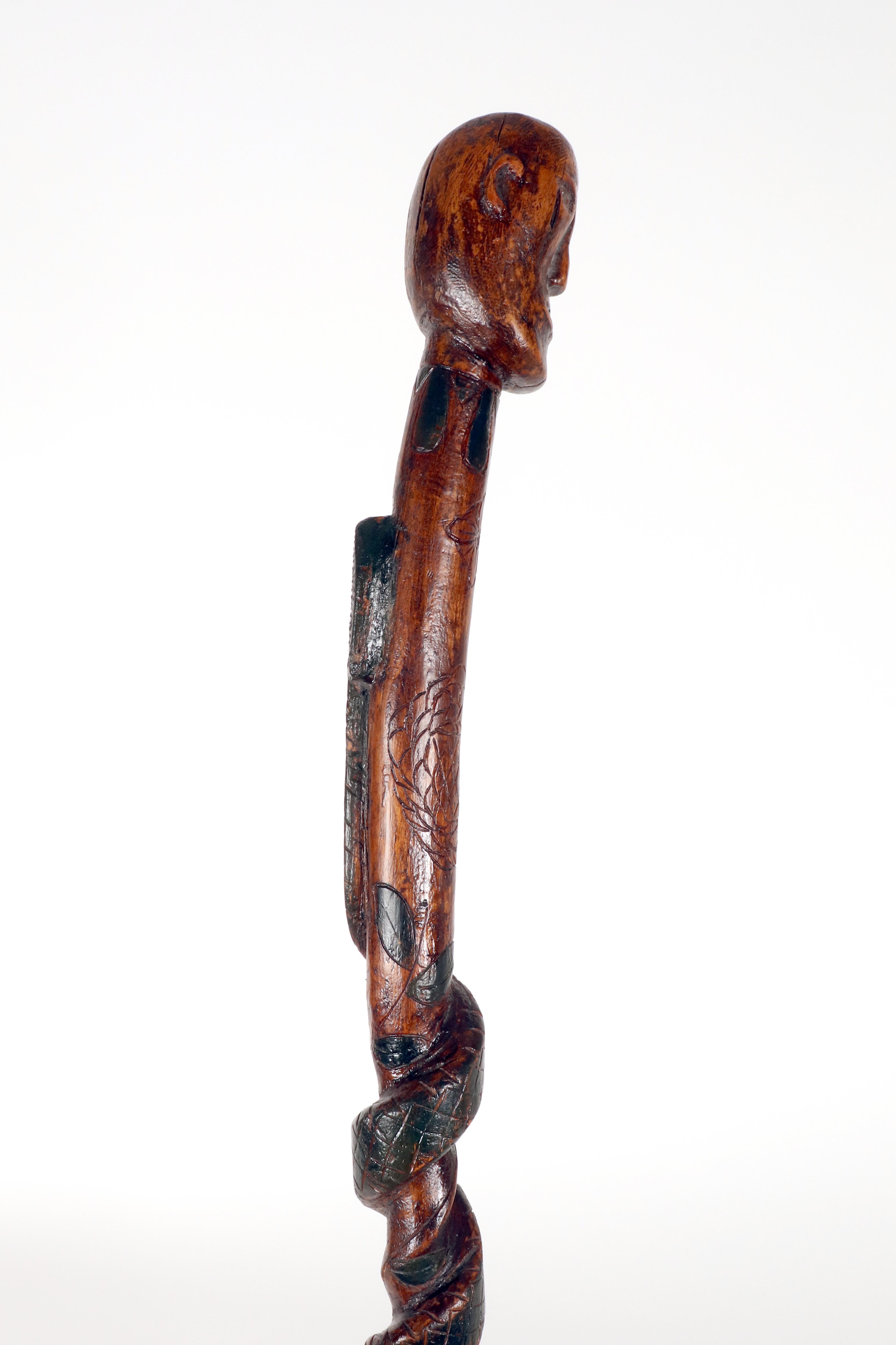 American Folk art walking stick depicting a man with a snake. USA circa 1870. For Sale