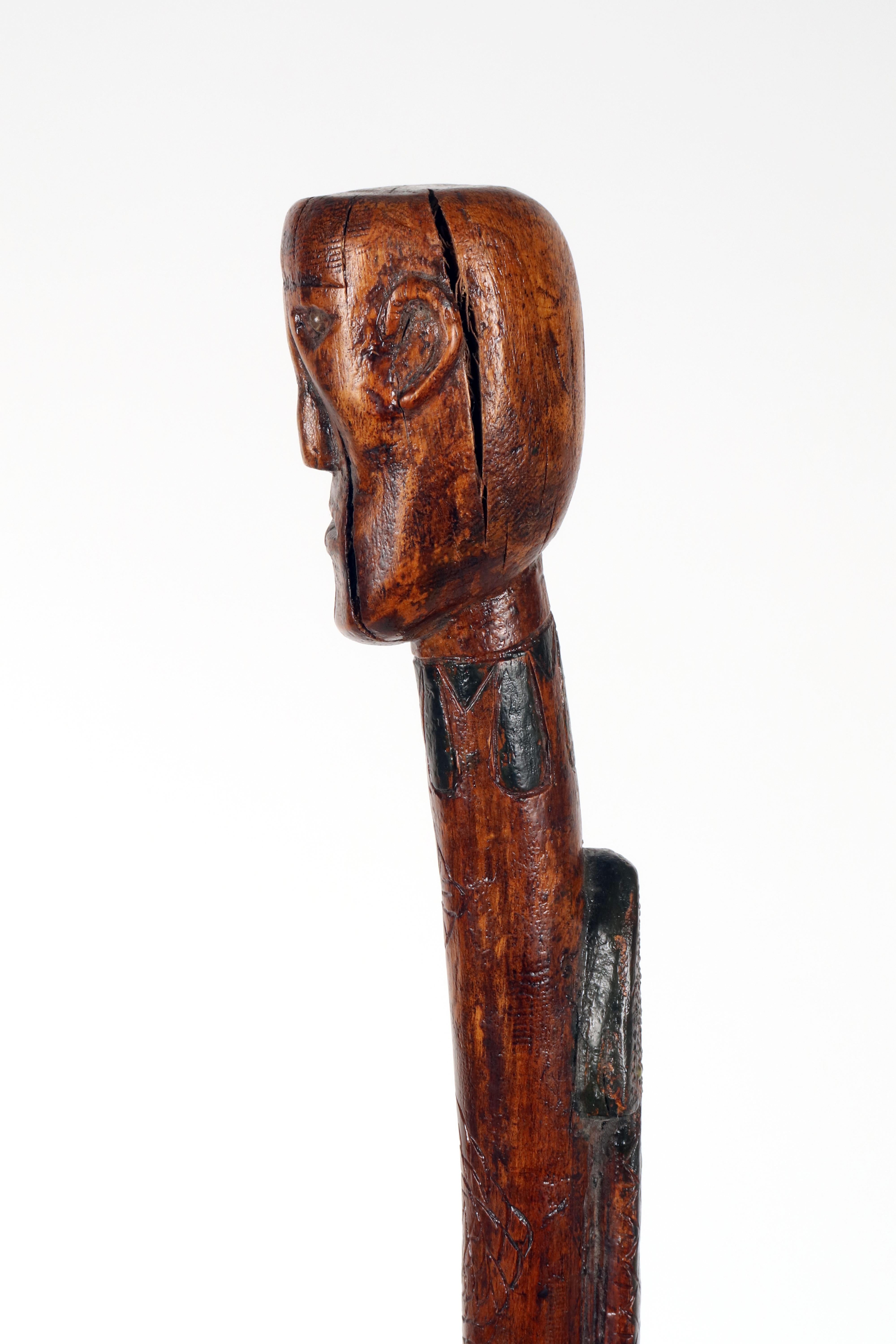 Fruitwood Folk art walking stick depicting a man with a snake. USA circa 1870. For Sale
