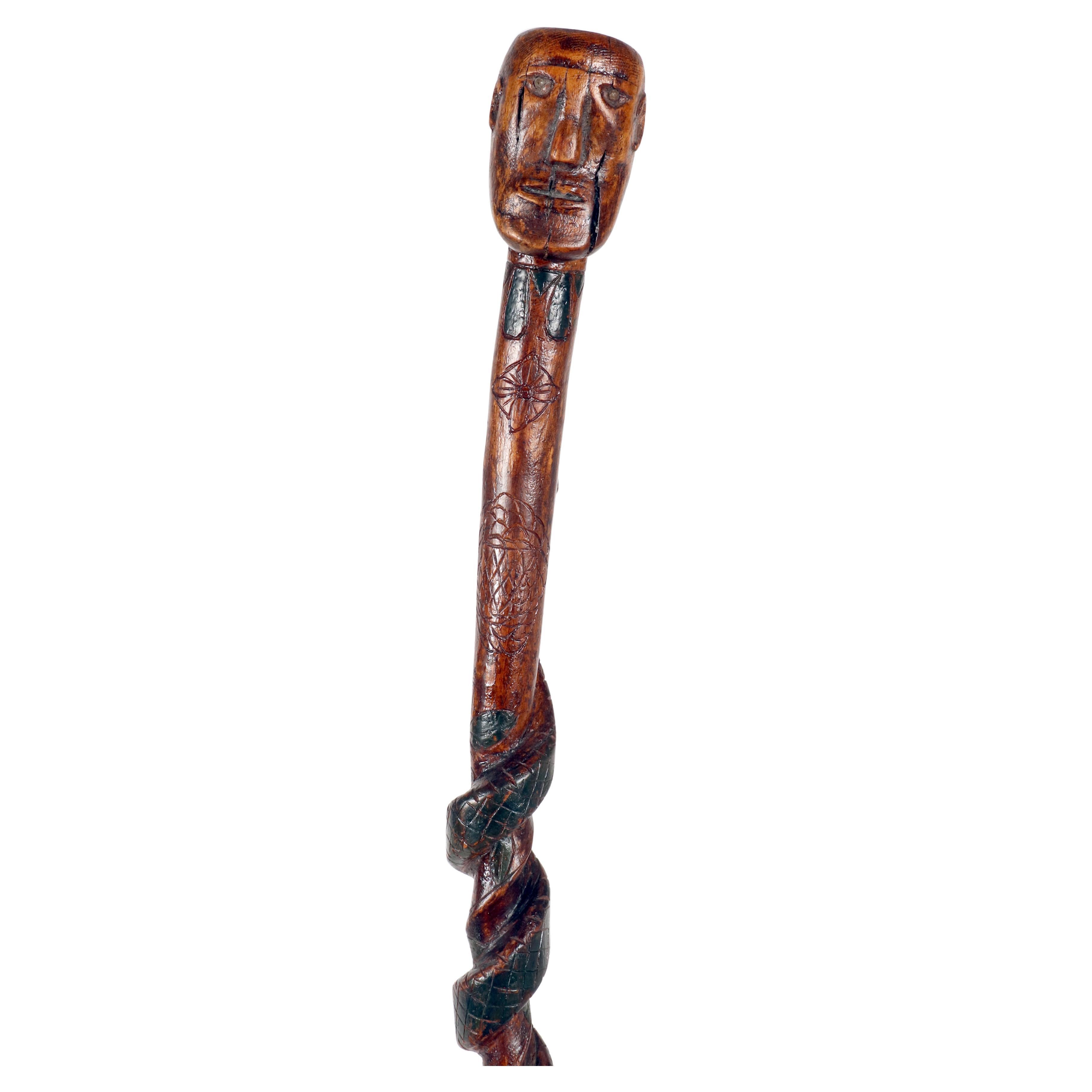 Folk art walking stick depicting a man with a snake. USA circa 1870. For Sale