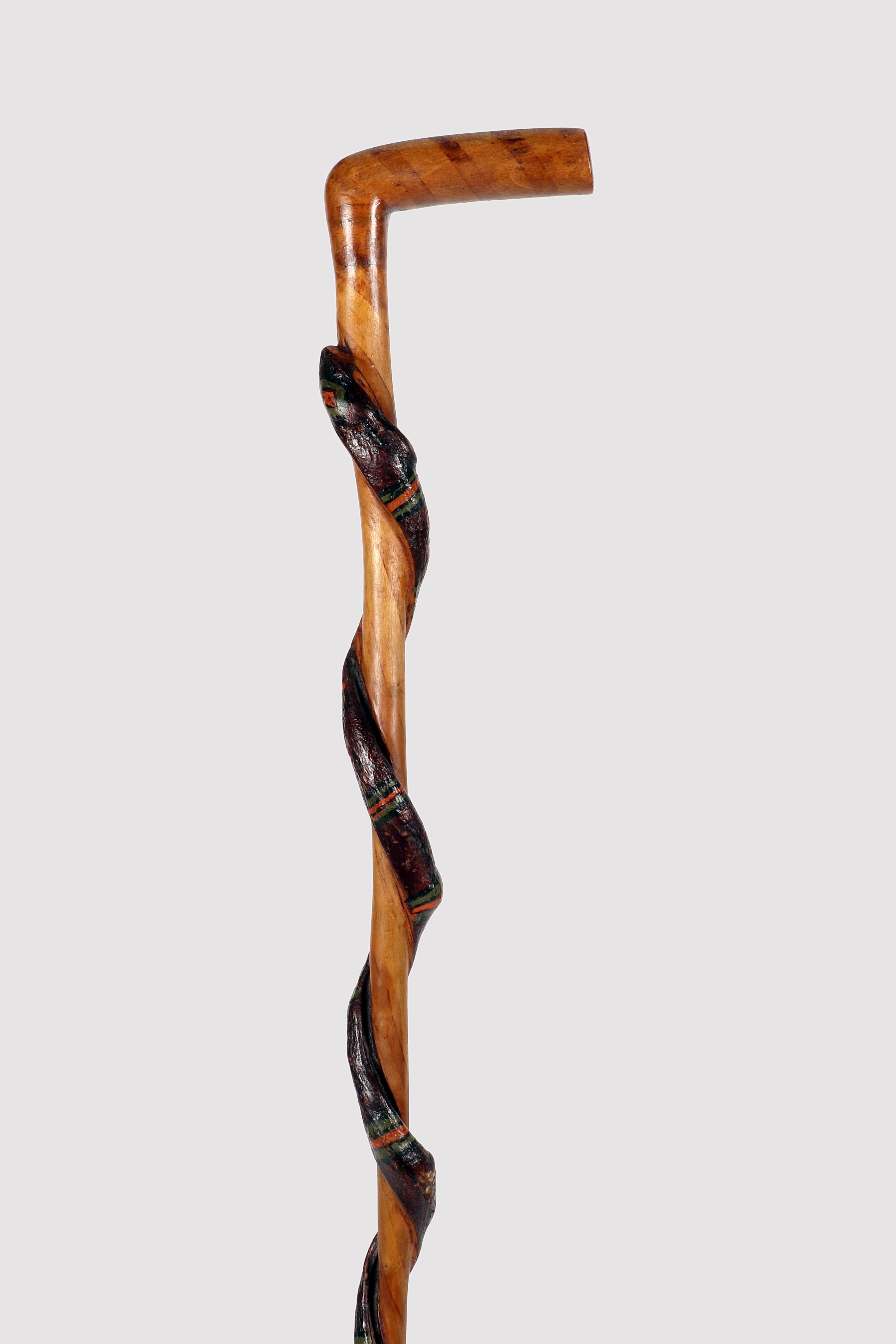 Folk art walking stick, L-shaped knob made of carved and painted cherry wood. Along the stem, obtained from the branch, a snake is carved which coils around the cane. The snake's skin is part of the bark of the cherry branch, with traces of green
