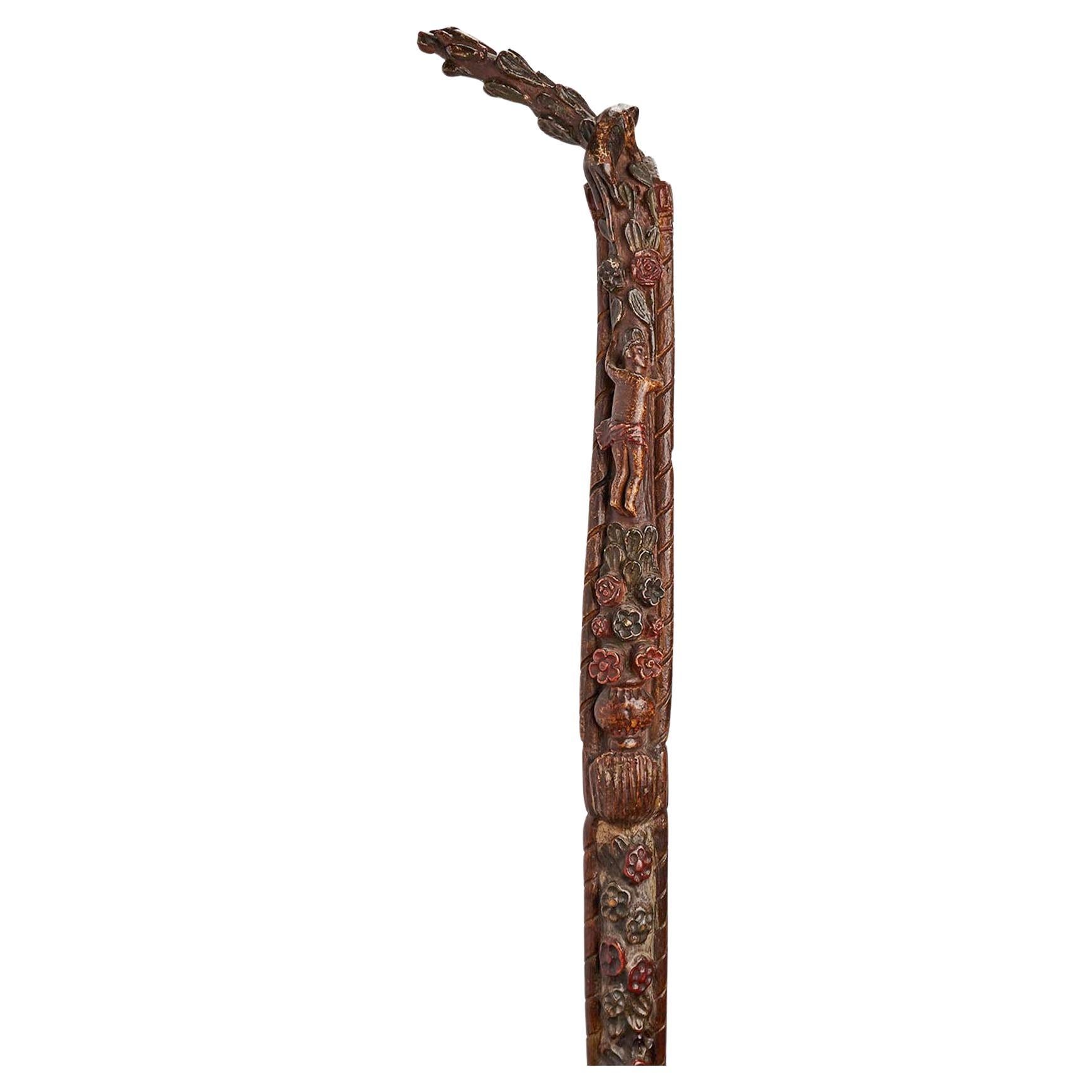 Folk art walking stick depicting flowers and characters, Russia 1830.
