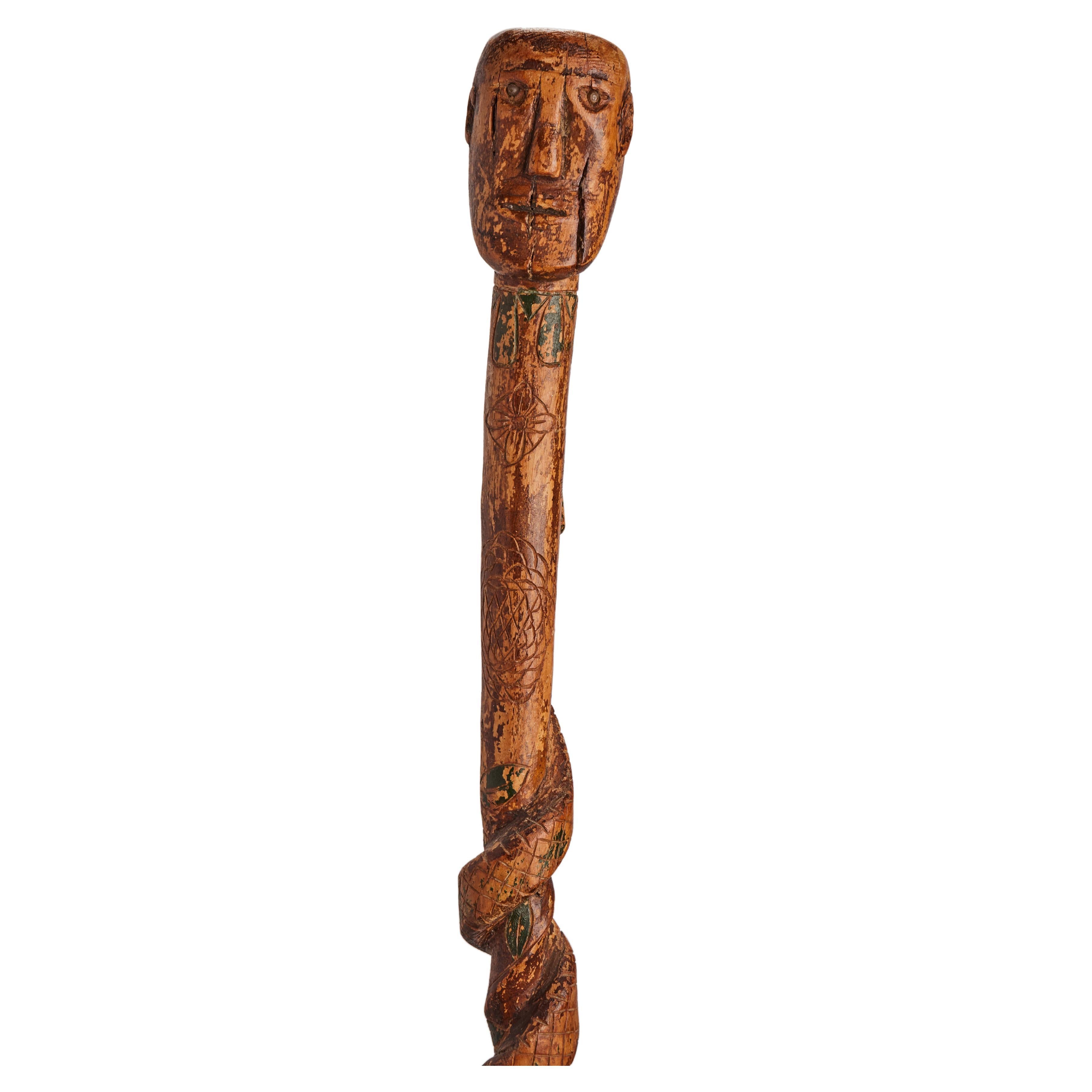 Folk art  walking stick depicting thehead of a man with a snake, USA 1880. For Sale