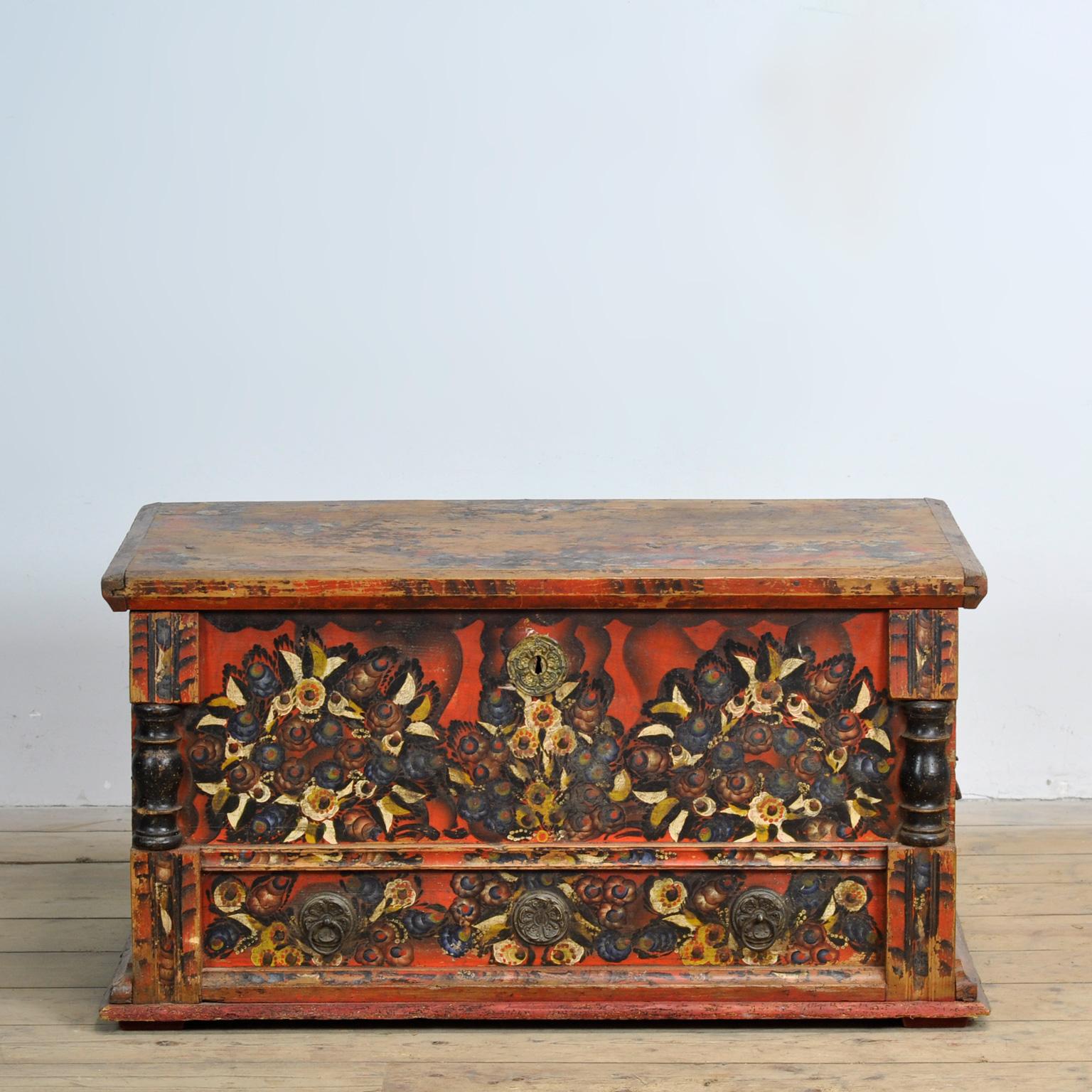 A pine wedding chest from Central Europe, probably German, circa 1850. The terracotta red color scheme is typical of the style and is often seen in Swedish and German painted furniture and harks back to the classical period. The flowers decorating