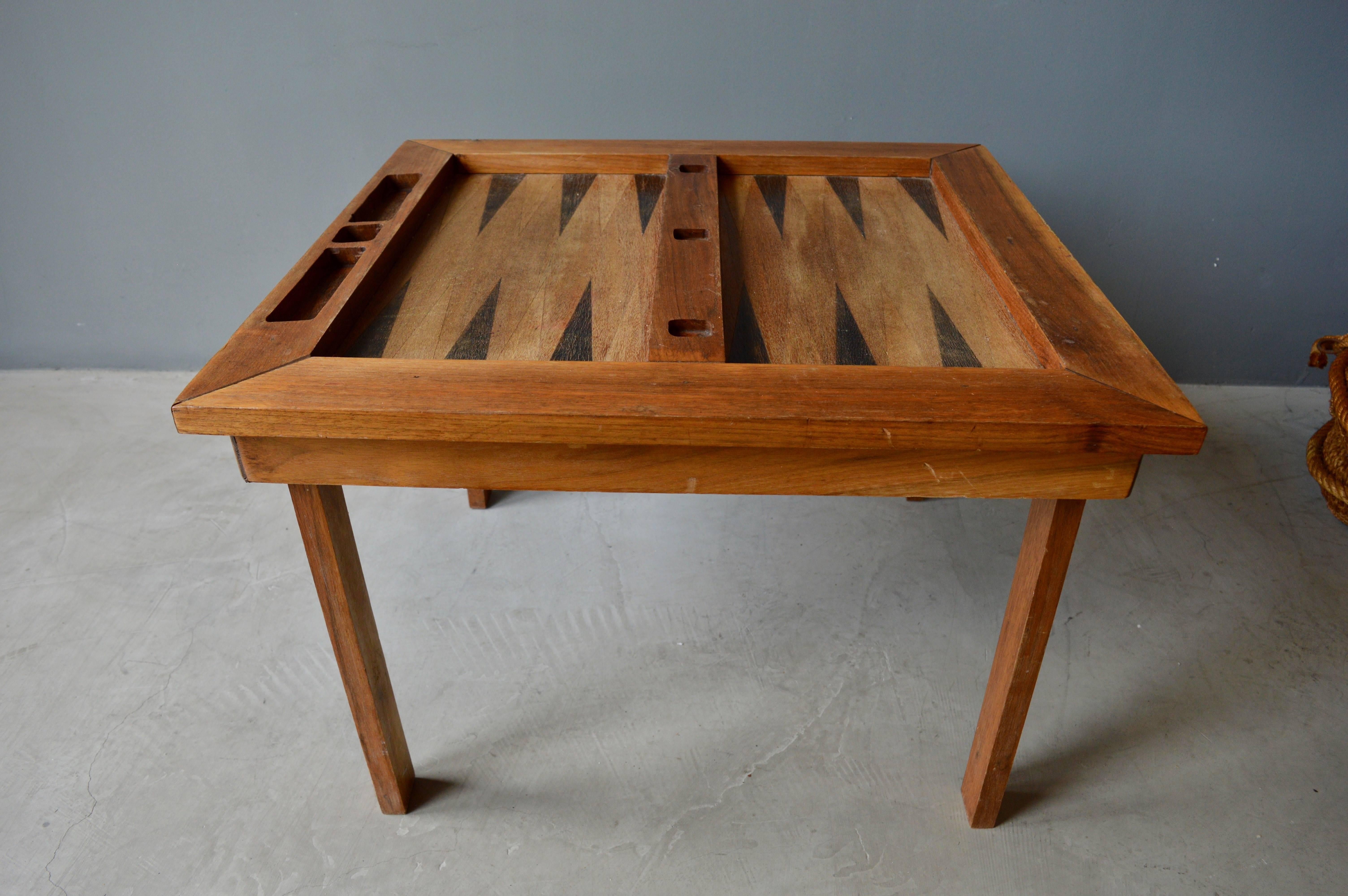 Great handmade folk art backgammon table. Great scale. Perfect as a side table between two chairs. Great sculptural piece. Excellent vintage condition.