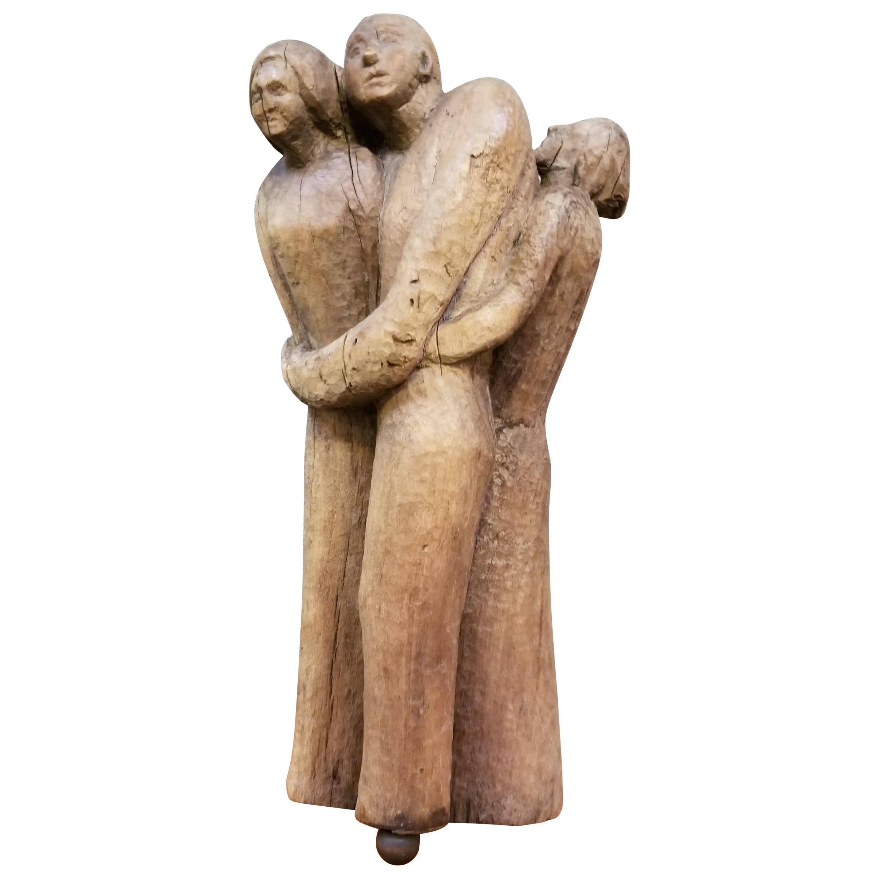 Folk Art Wood Carved Sculpture of 3 Embracing Figures For Sale