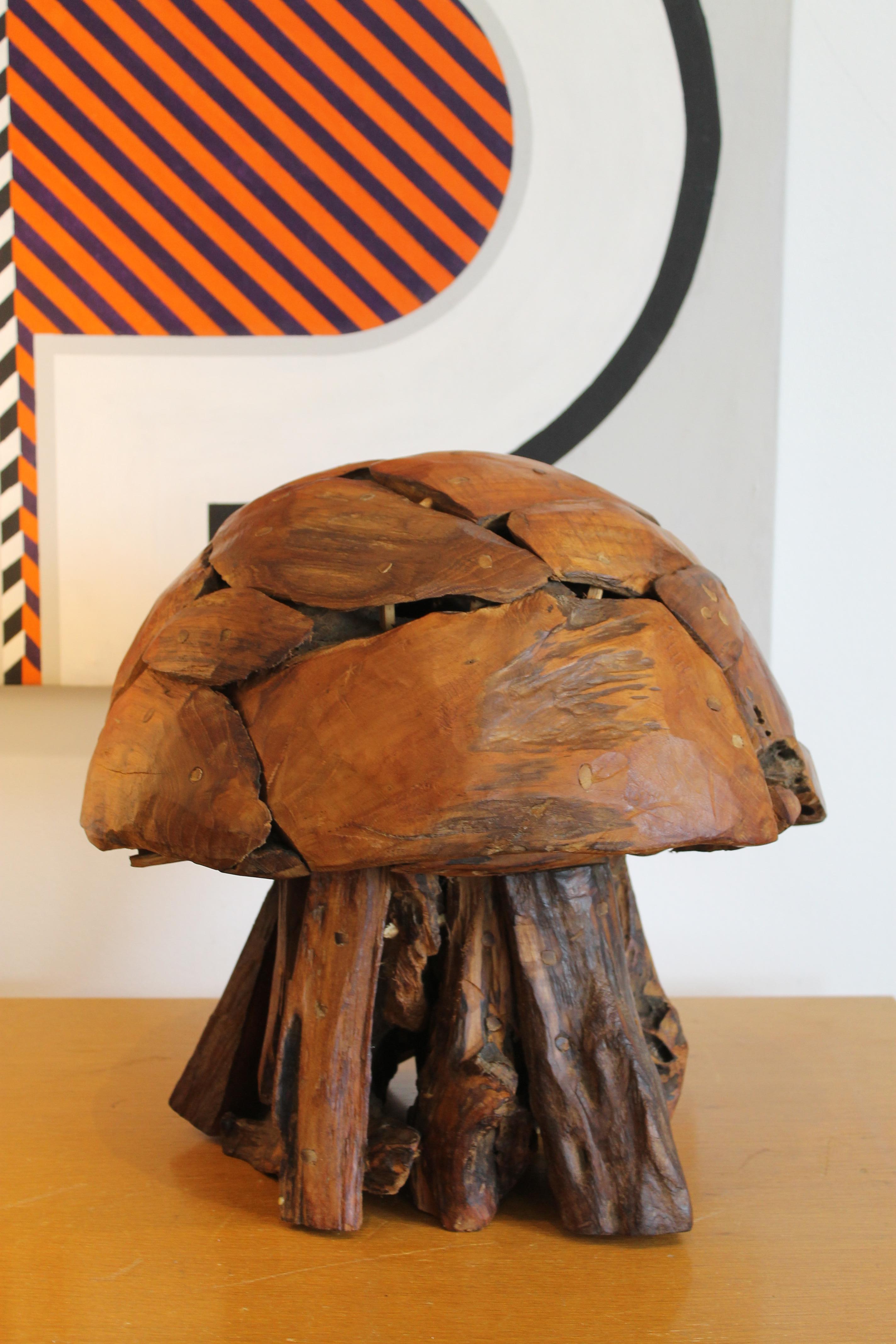 An impressive wood sculpture in the form of a mushroom. Wood fragments are assembled and all secured with wooden dowels. No nails or screws were used. Solid heavy piece. Measures 16.5