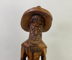 Folk Art Wood Sculpture of a  Caribbean Man Holding a Pineapple