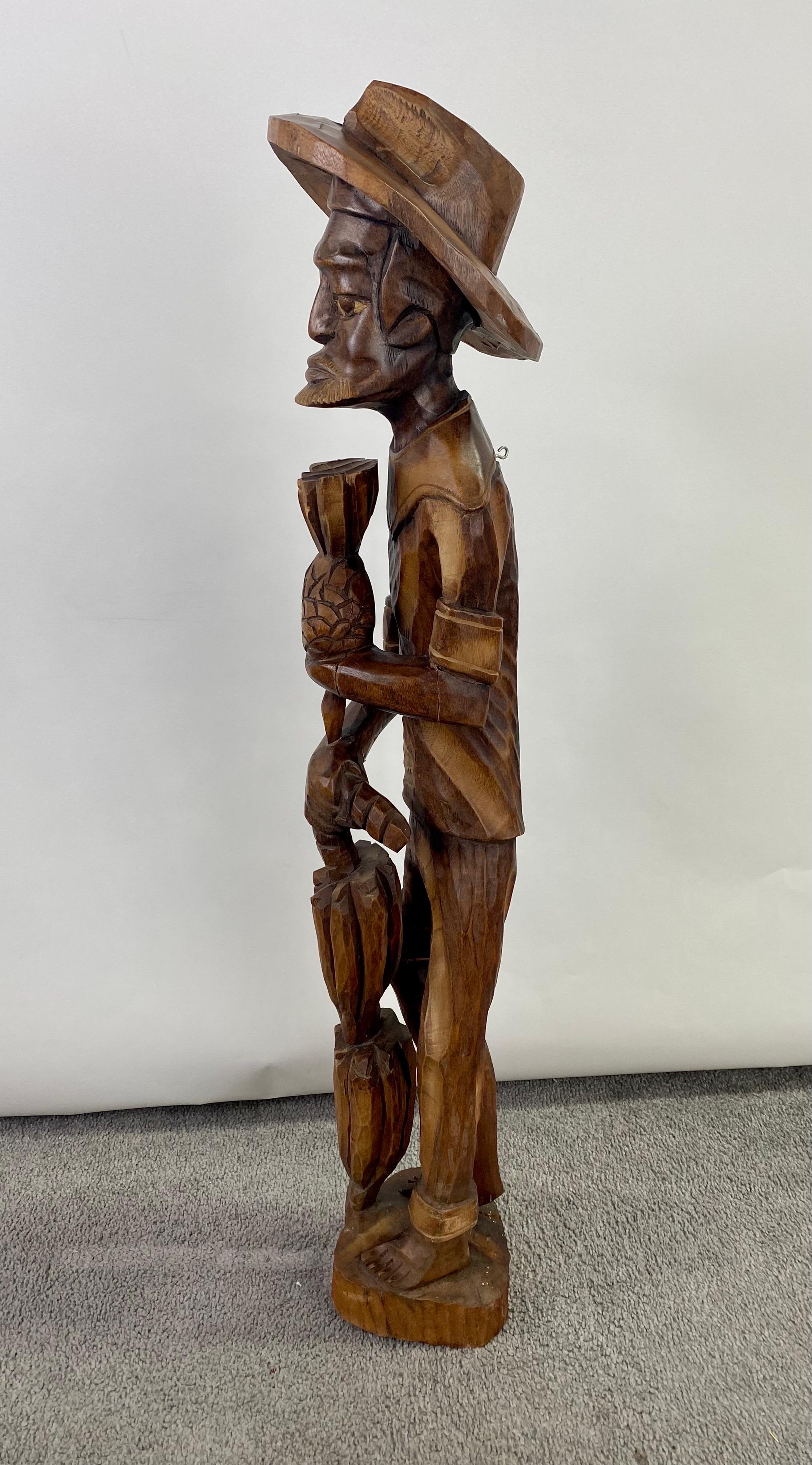 20th Century Folk Art Wood Sculpture of a  Caribbean Man Holding a Pineapple  For Sale