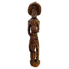 Used Folk Art Wood Sculpture of a  Caribbean Man Holding a Pineapple 