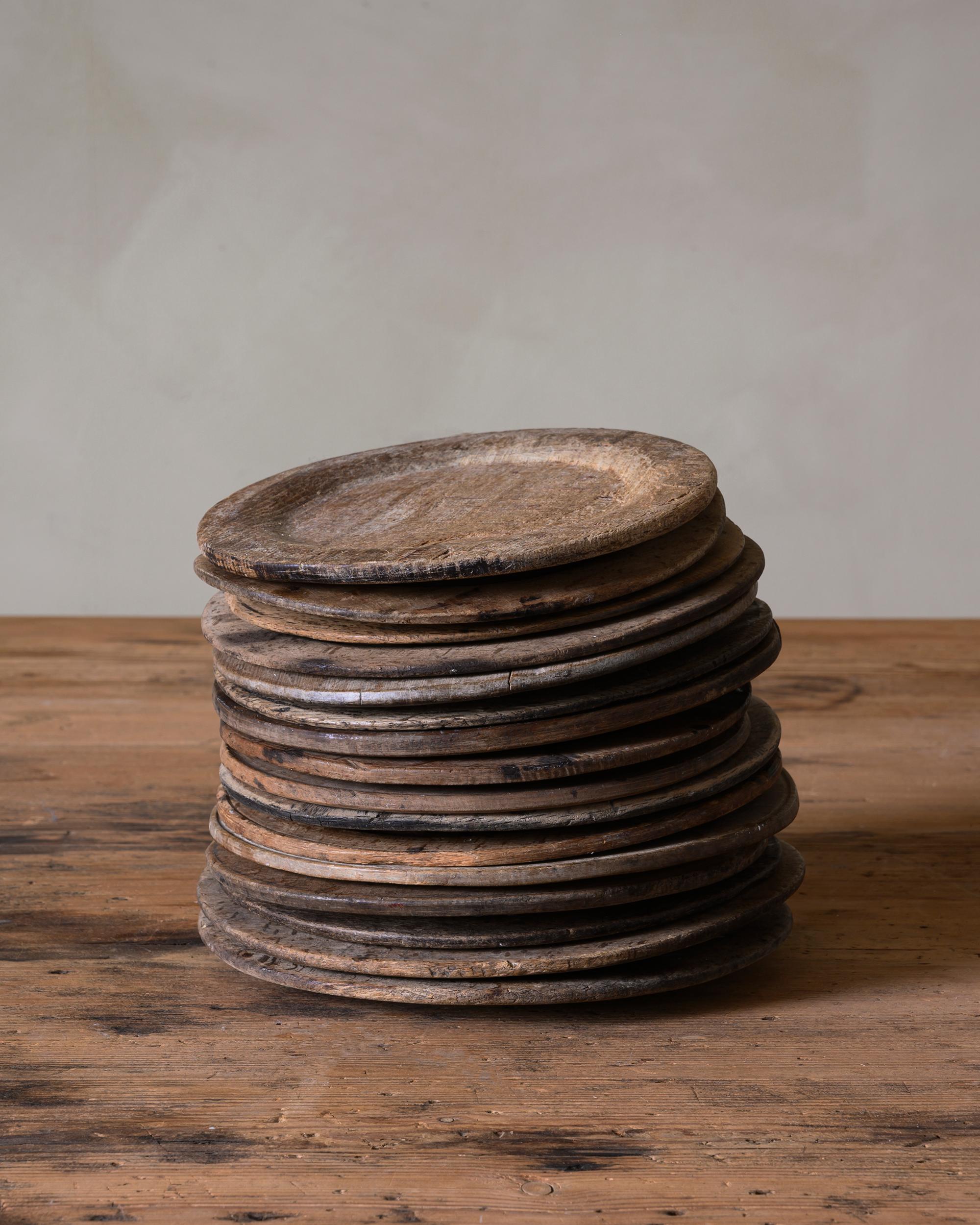 Charming set of 16 Swedish 18th - 19th century Folk Art wooden dinner plates. Dimensions: The diameter vary from 16 - 19 cm. Great for trays, platers or under-plates.