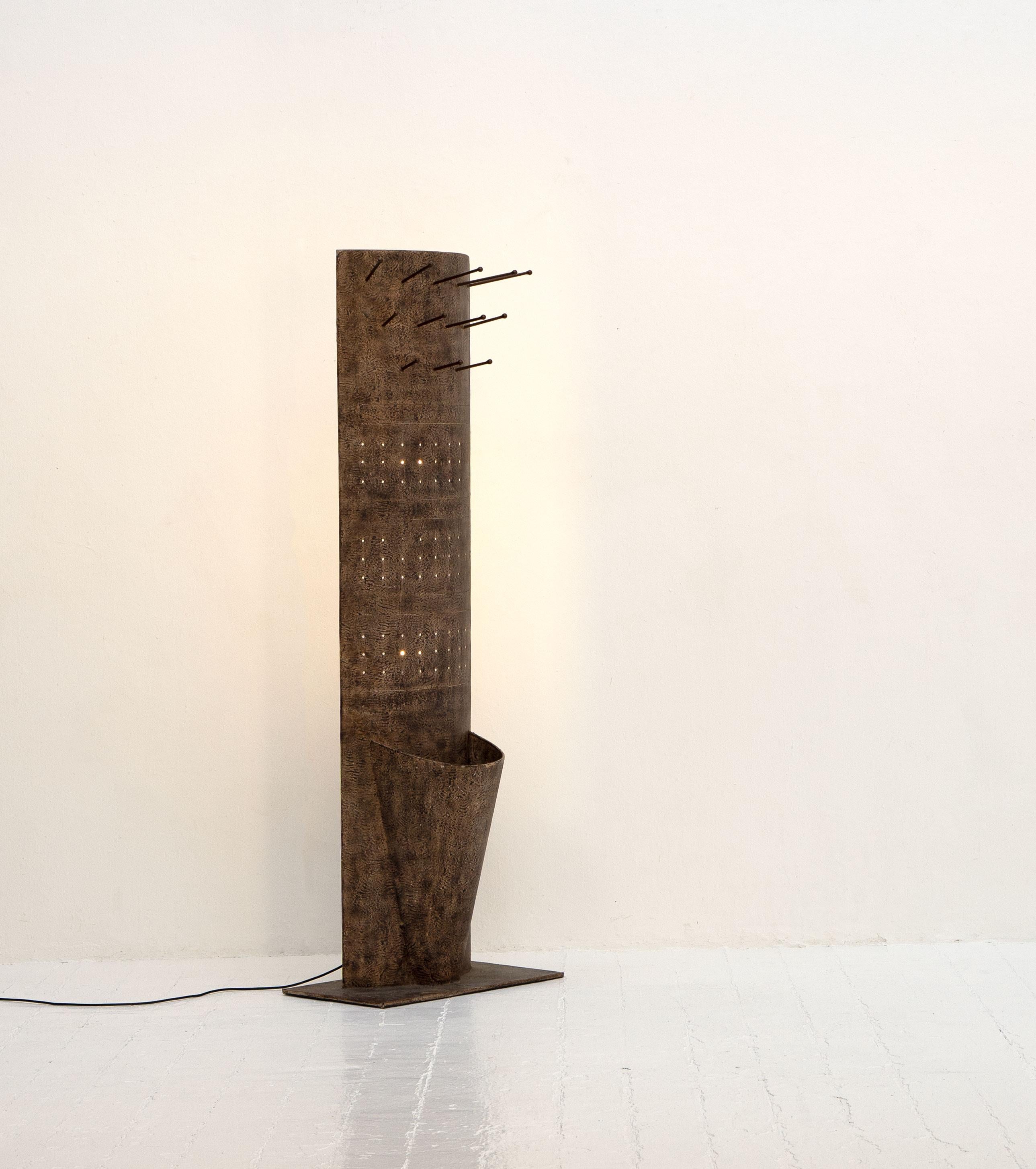 A very unusual hall stand, handmade in France in the 1980's. Formed from painted sheet metal, the stand has coat hooks, an umbrella holder and is illuminated by two lamps to the rear, the light from which can be seen through perforations in the