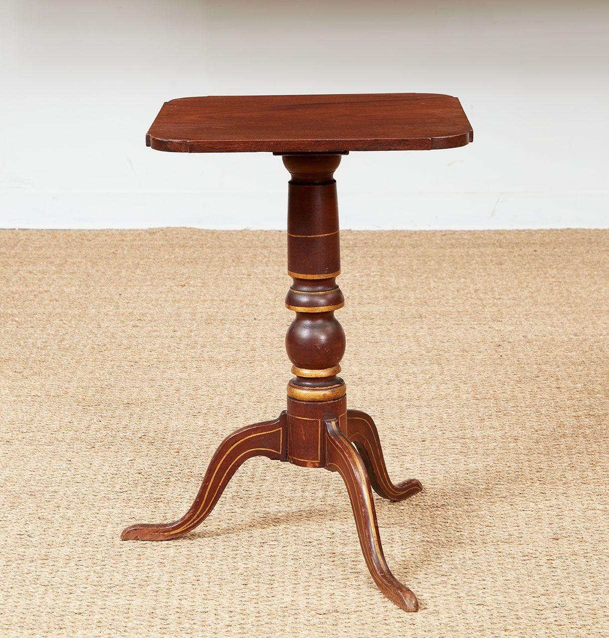 A rare early 19th century American mahogany tripod pedestal table retaining original folk line painting to turned shaft and shaped feet.  Featuring a square single plank top with shaped corners in fine quality mahogany with swirl grain.  Circa 1820