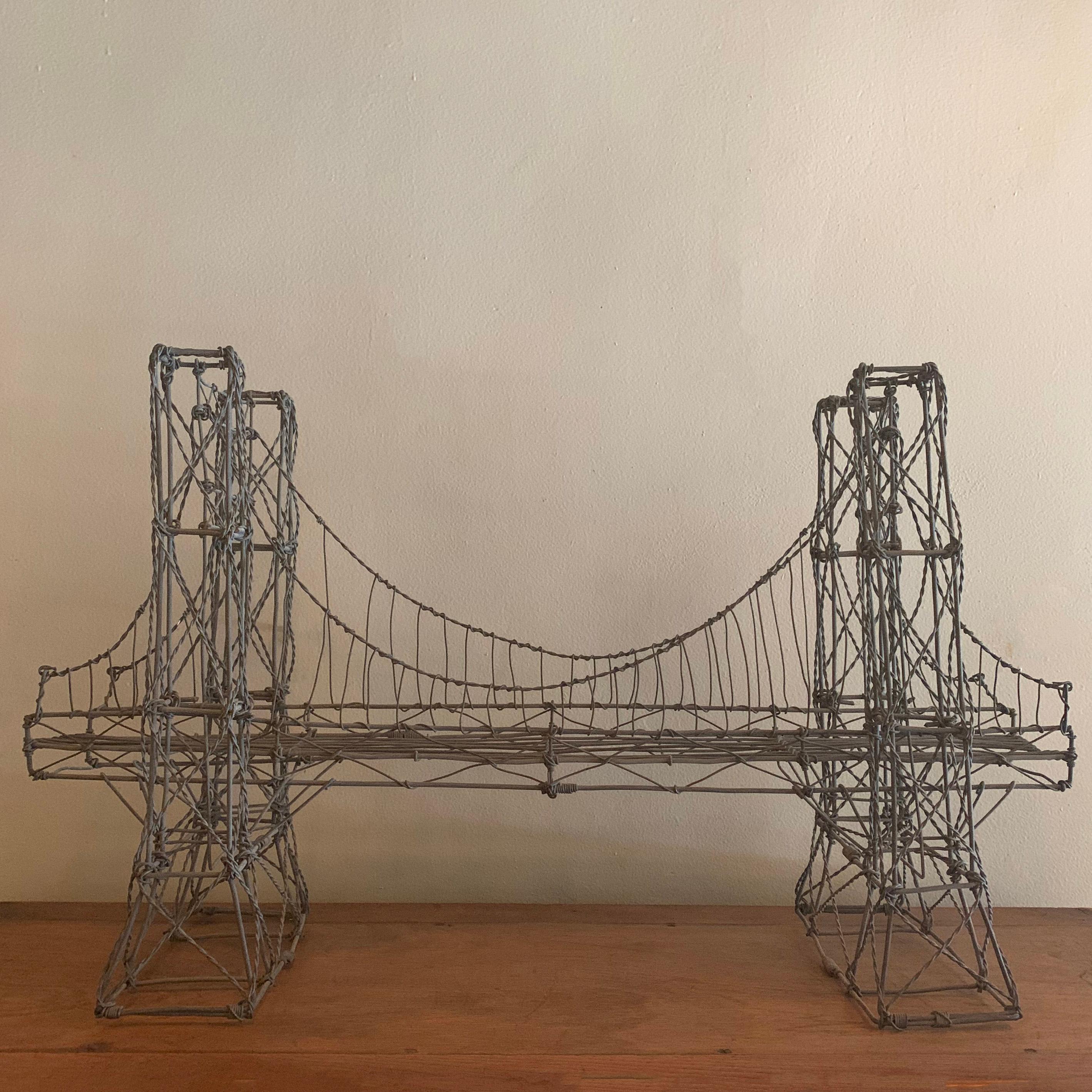 Artisan-made, street art, folk art, galvanized wire sculpture of a bridge.