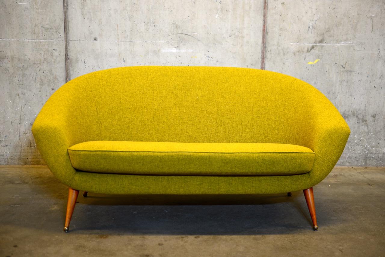 Scandinavian midcentury sofa model Tellus by Swedish designer Folke Jansson. Brown lacquered legs with brass balls as feet, recently reupholstered in wool fabric from Kvadrat. Produced in the 1950s in Sweden by SM Wincrantz. Quality and time-less