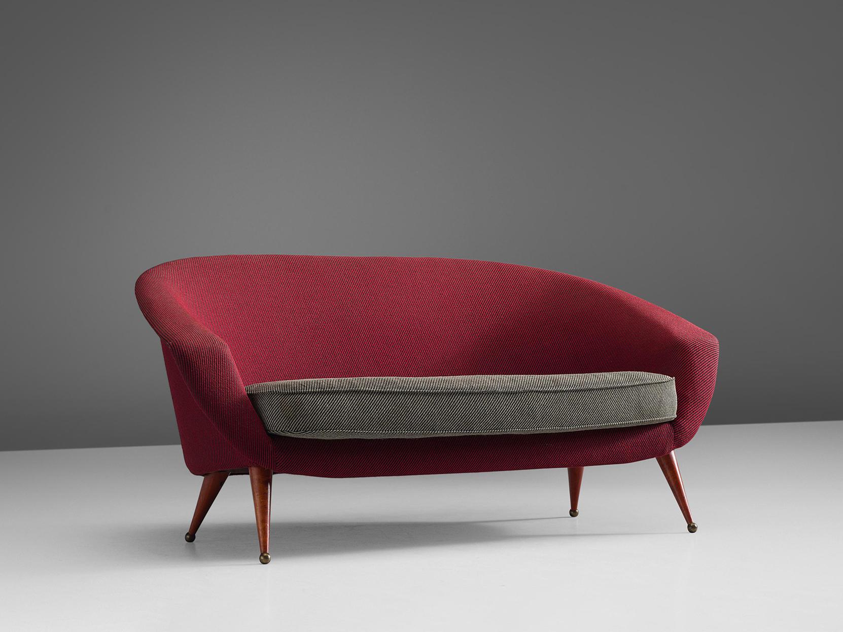 Folke Jansson, sofa model 'Tellus', fabric, wood, brass, Sweden, designed in 1956.

This sofa is crafted by Swedish designer Folke Jansson and embodies an elegant body with flowing lines. Four tapered, stained wooden legs, are adorned with an