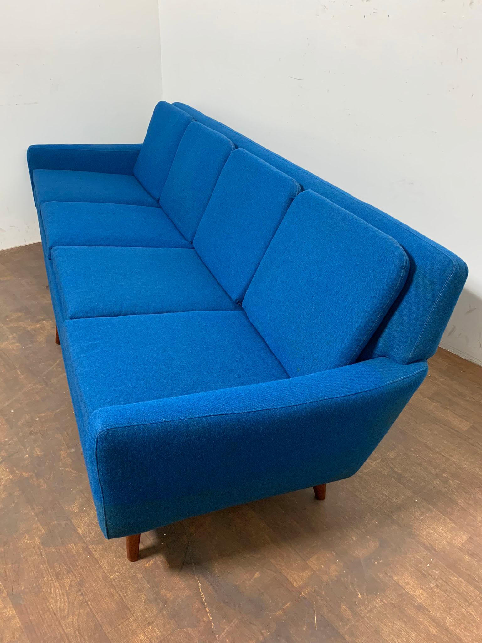 Four seat sofa by Folke Ohlsson for Dux, circa 1960s. As a young Swedish designer, Ohlsson was sent by Dux to California in the early 1950s to establish a factory there to produce furniture for the booming postwar market. Thus, this classic