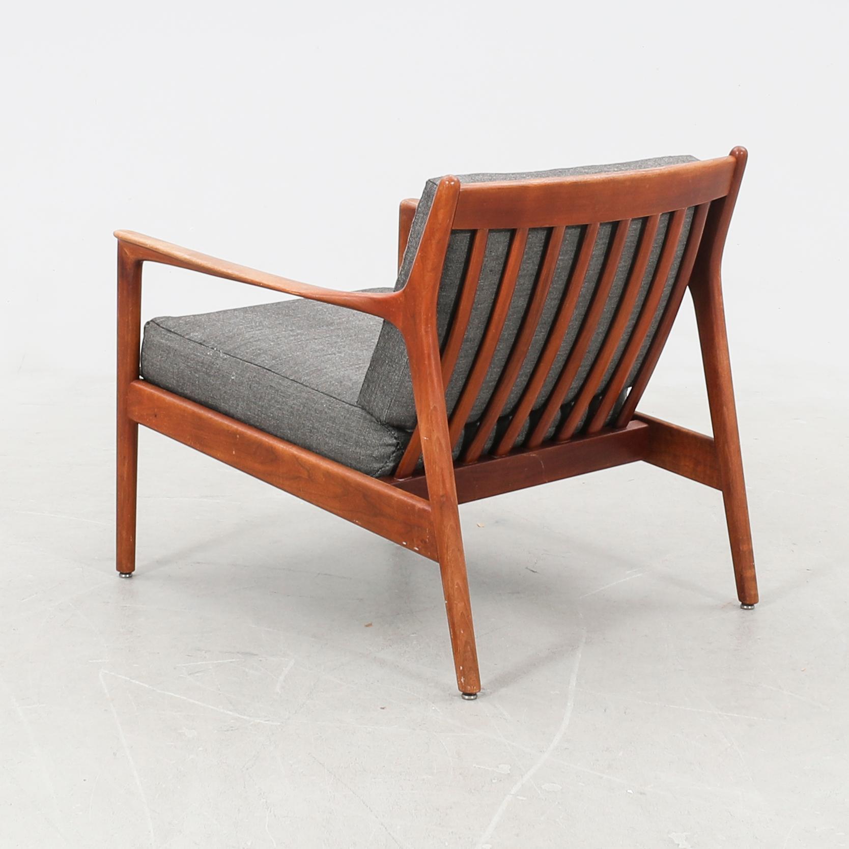 Timeless Scandinavian design with this  Folke Ohlsson armchair, Model USA, made by  DUX of Sweden n in the 1960s. The chair features a beautifully crafted teak wood frame paired with a detachable fabric cushions for added comfort and easy
