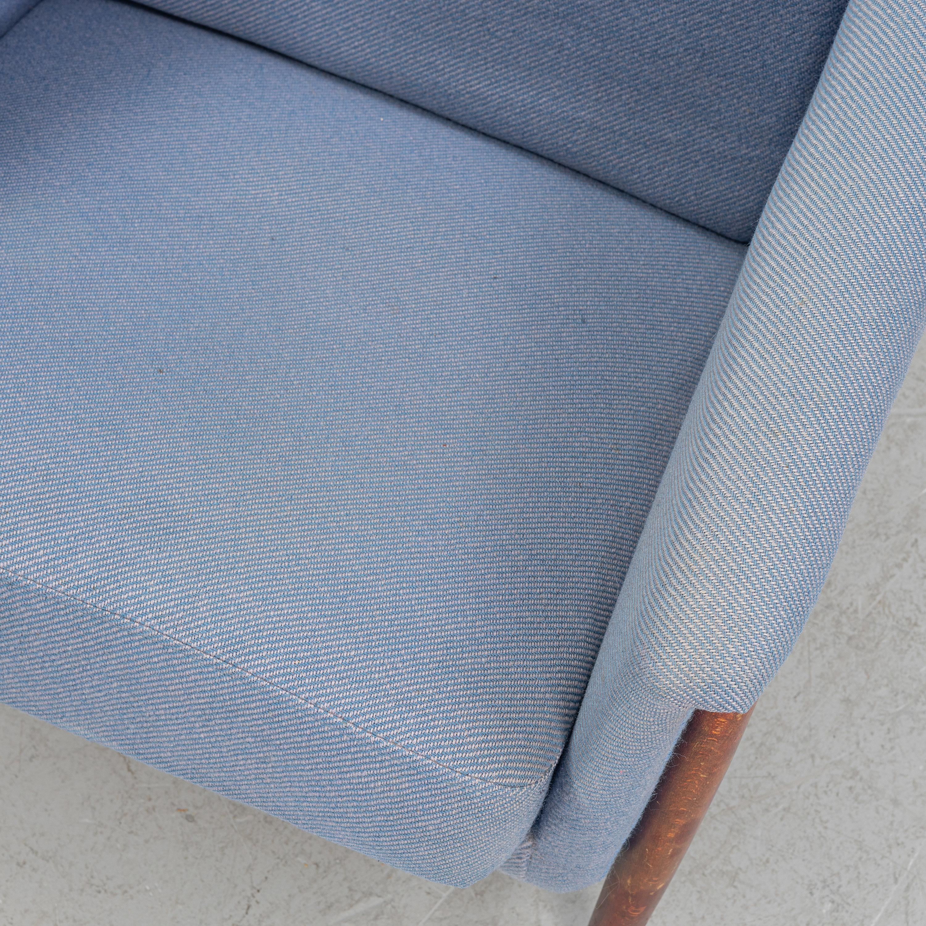 'Scania'' armchair designed by Folke Ohlsson for Dux in Sweden around 1960 .Manufactured in Stained Beech, brass and upholstery. Good condition with original light blue fabric . 
Folke Ohlsson was a Swedish designer considered one of the most