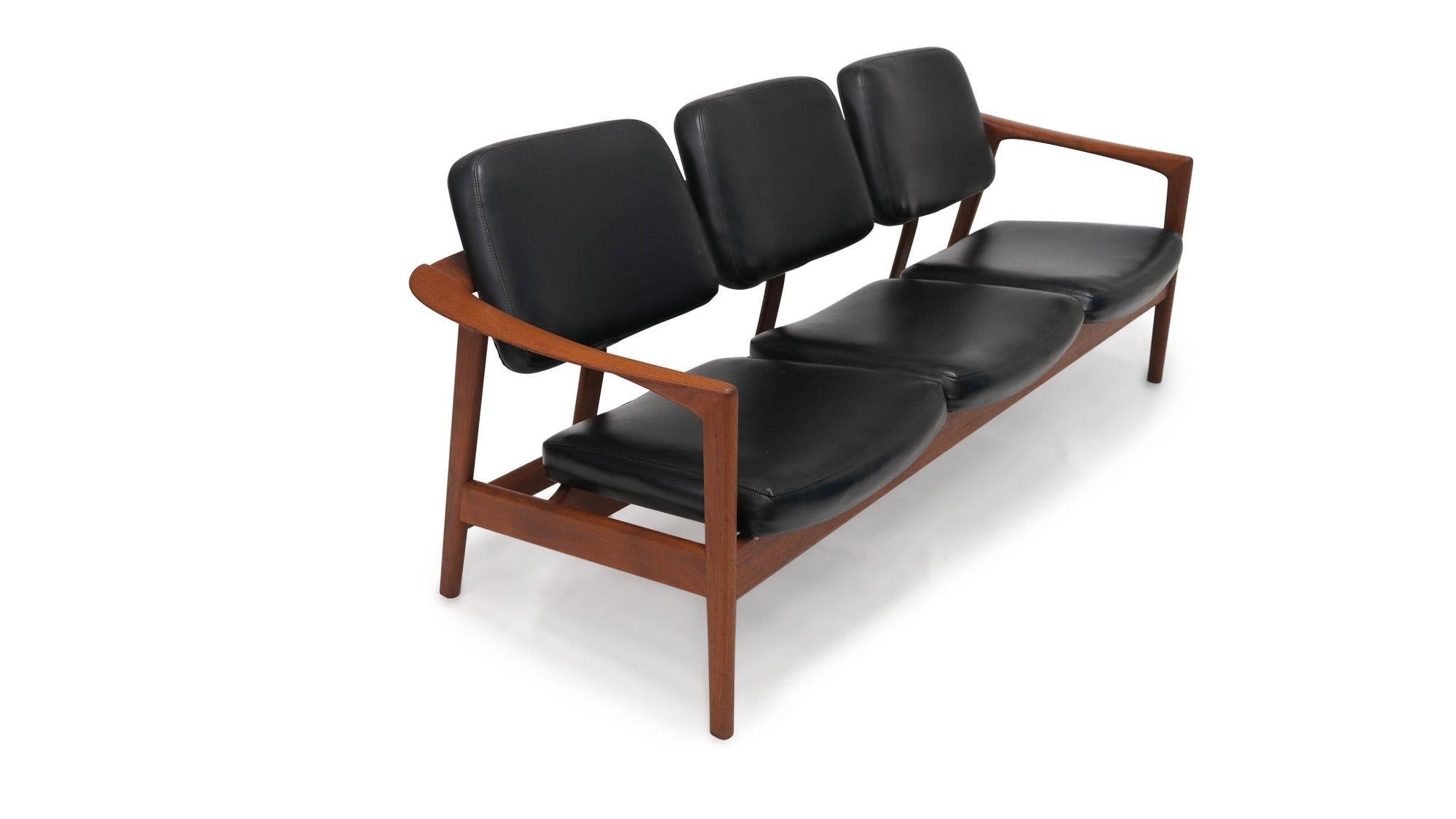 Sofa designed by Folke Ohlsson, 1965, Sweden. The sofa is crafted of sculpted teak frame with original black vinyl upholstered seats and backs. Rare model. Perfect for residential or commercial environment
Measurements W 73'' x D 27.50'' x H