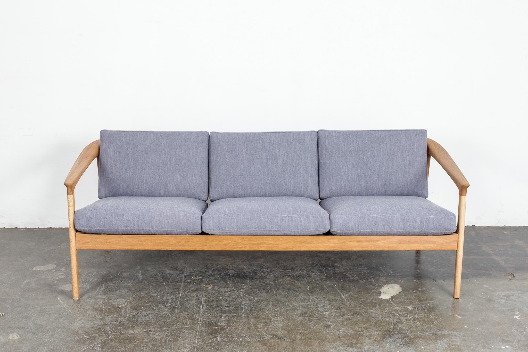 Beautiful solid oak spindle back 'Colorado' sofa designed by Folke Ohlsson for Bodafors, Sweden, 1960s. Newly refinished in a natural wax finish and newly upholstered in a blue woven fabric. Measures: Arm height is 21