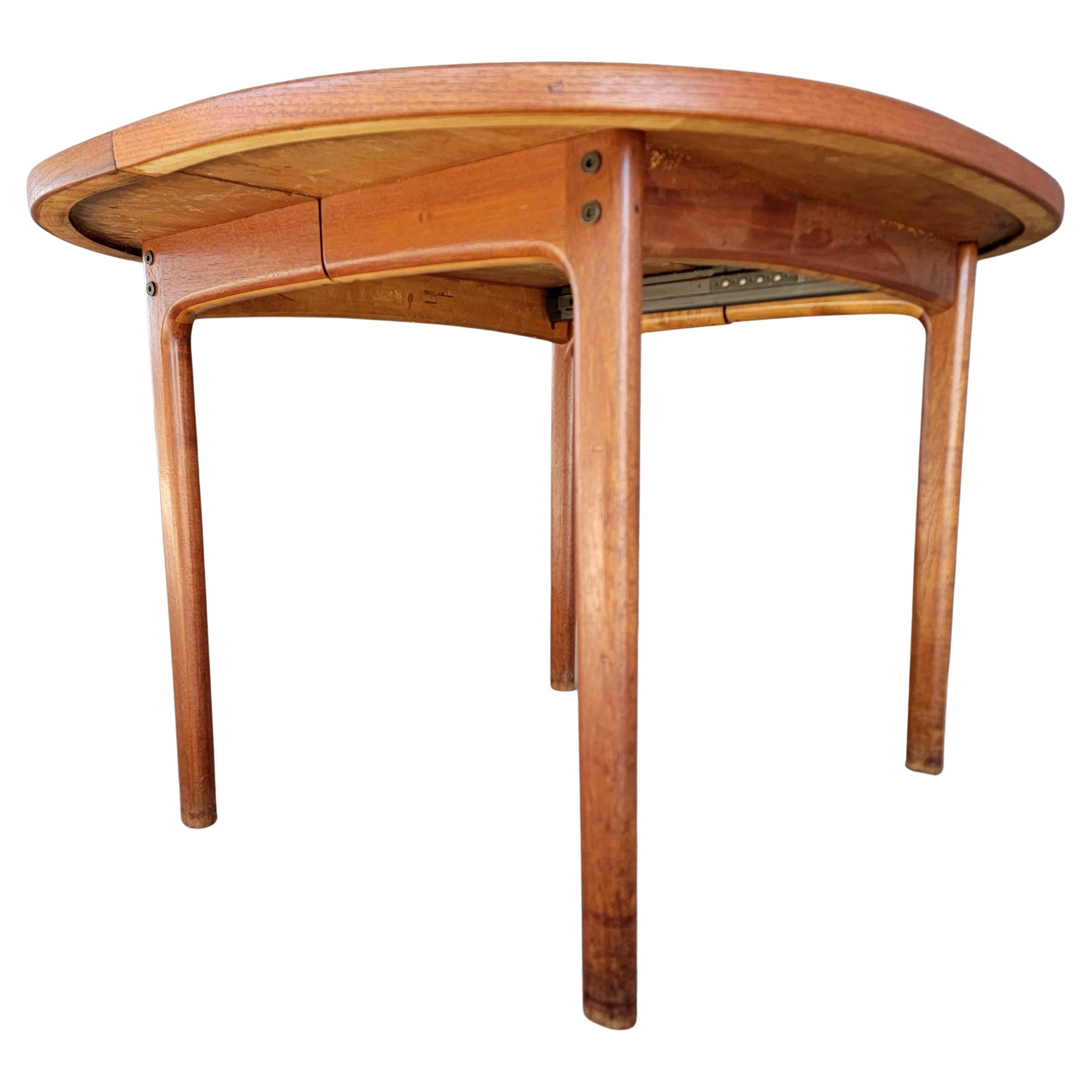 An oval teak Danish Modern expanding dining table designed by Folke Ohlsson for DUX of Sweden. Circa. 1960's. Branded on table stretcher 