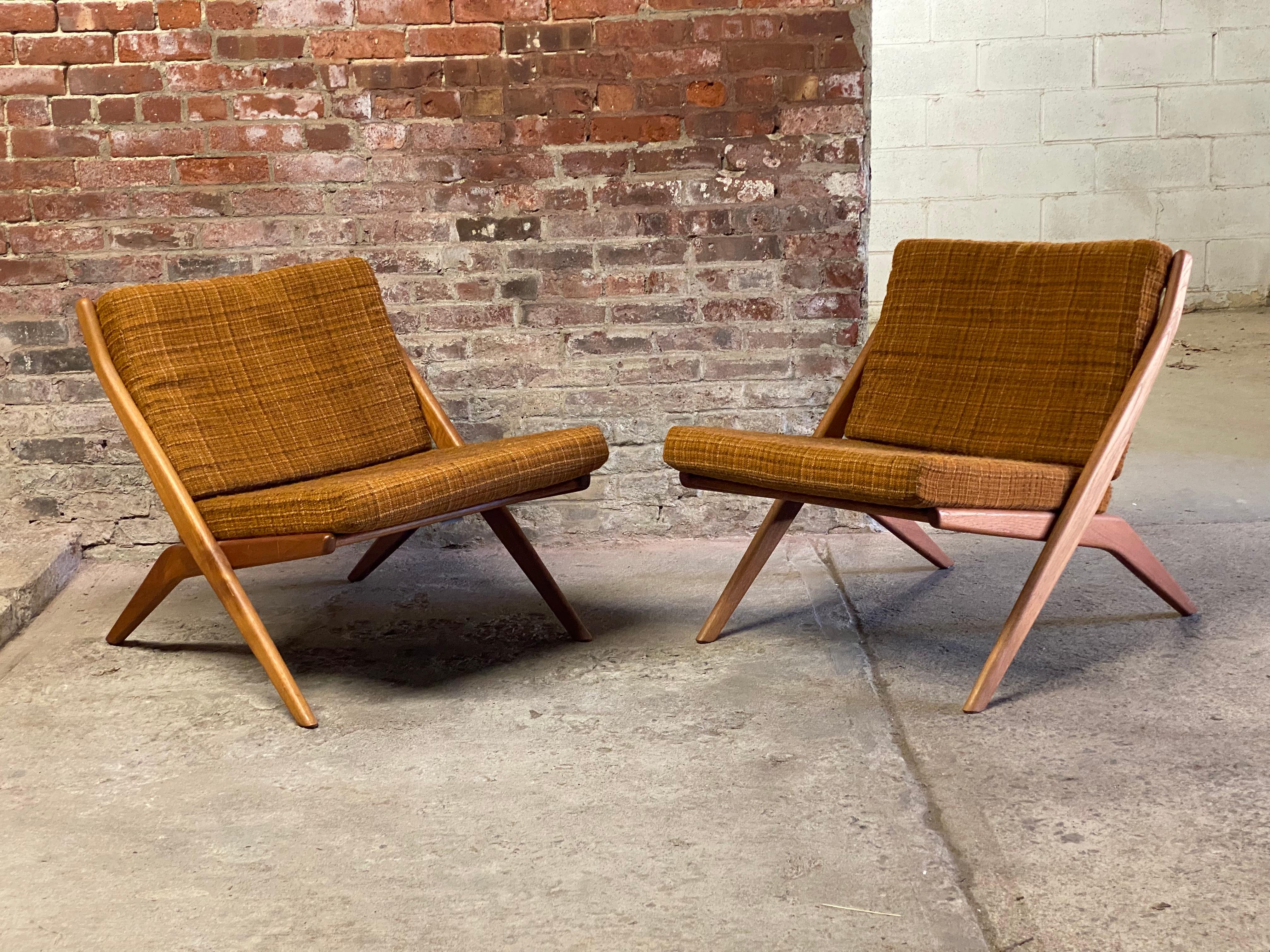 Pair of Folke Ohlsson designed scissor chairs for Dux of Sweden. Solid teak construction with very clean original oiled finish. Ergonomically slatted back contour and tapered legs. Good overall condition. Structurally sound and sturdy design.