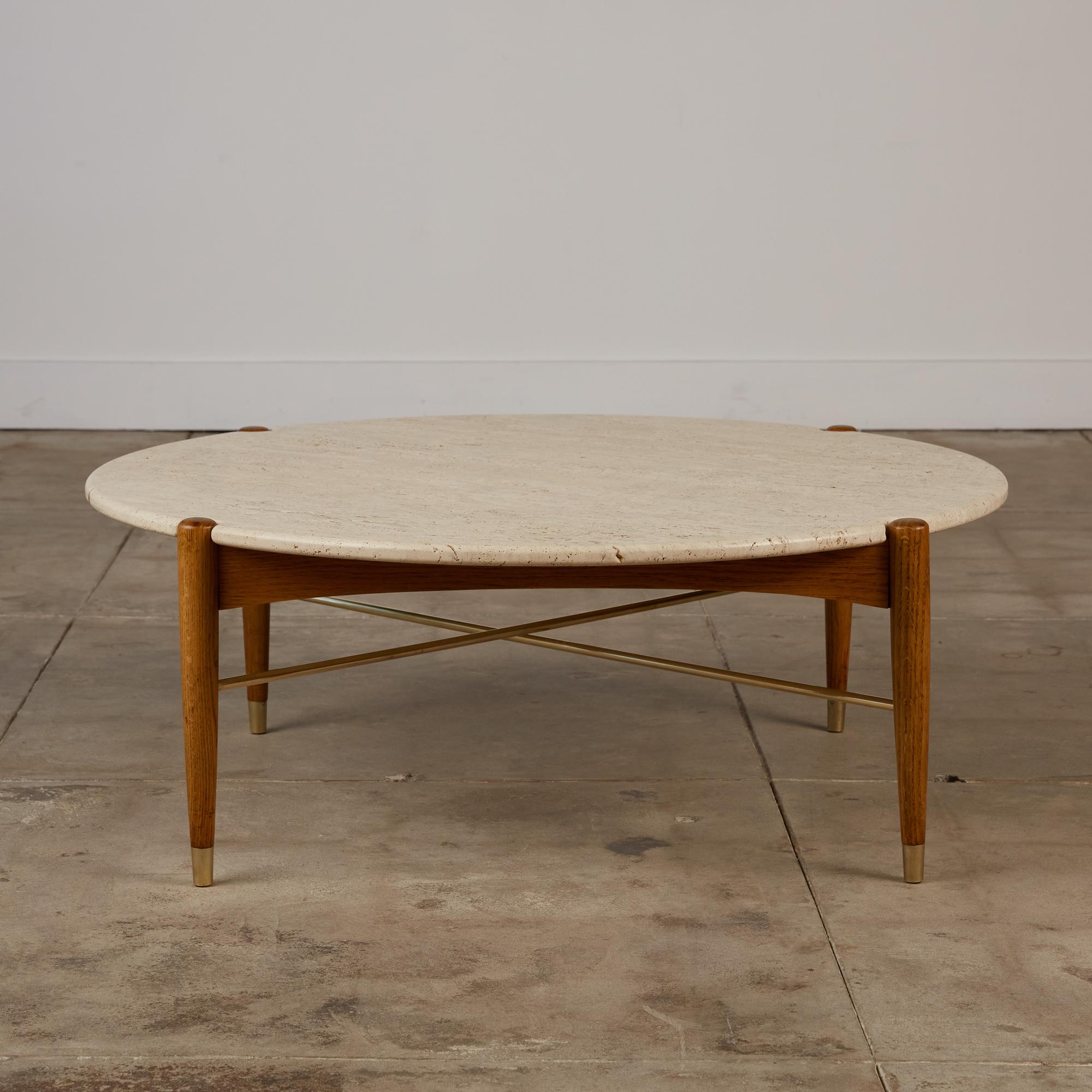 Travertine coffee table by Folke Ohlsson for DUX, Sweden. c.1960s. The table features a round oak base and brass X-stretcher. The rounded edge travertine top is crafted to sit perfectly on top of the base to show the tops of the legs. The legs peek