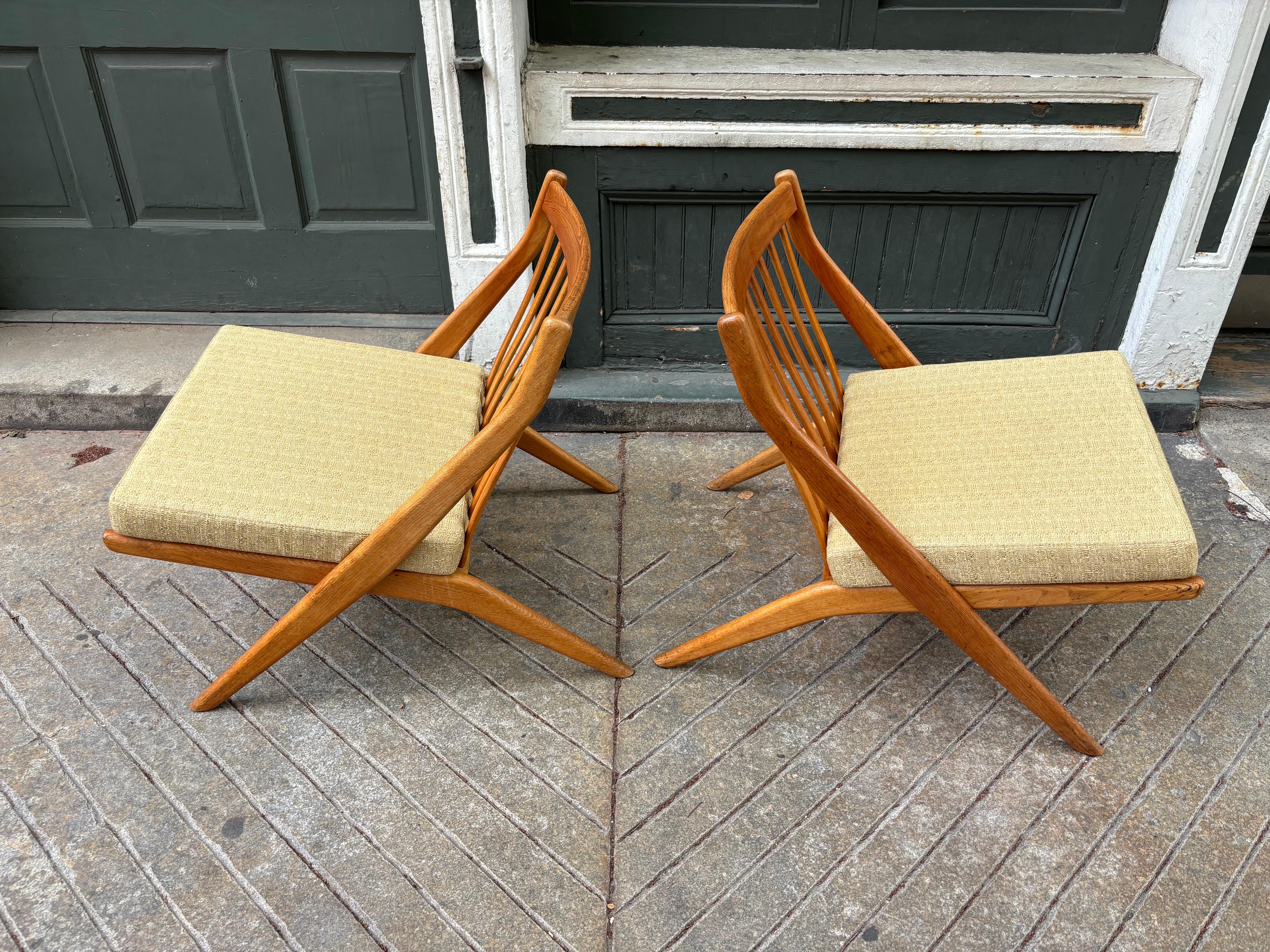 Folke Ohlsson for DUX of Sweden Pair of Scissor Chairs.  Oak frames with slat backs and removable Upholstered Cushions.  Chairs were reupholstered about 15 years ago.  Fabric still looks good with slight overall fading.  Chairs are very solid! 