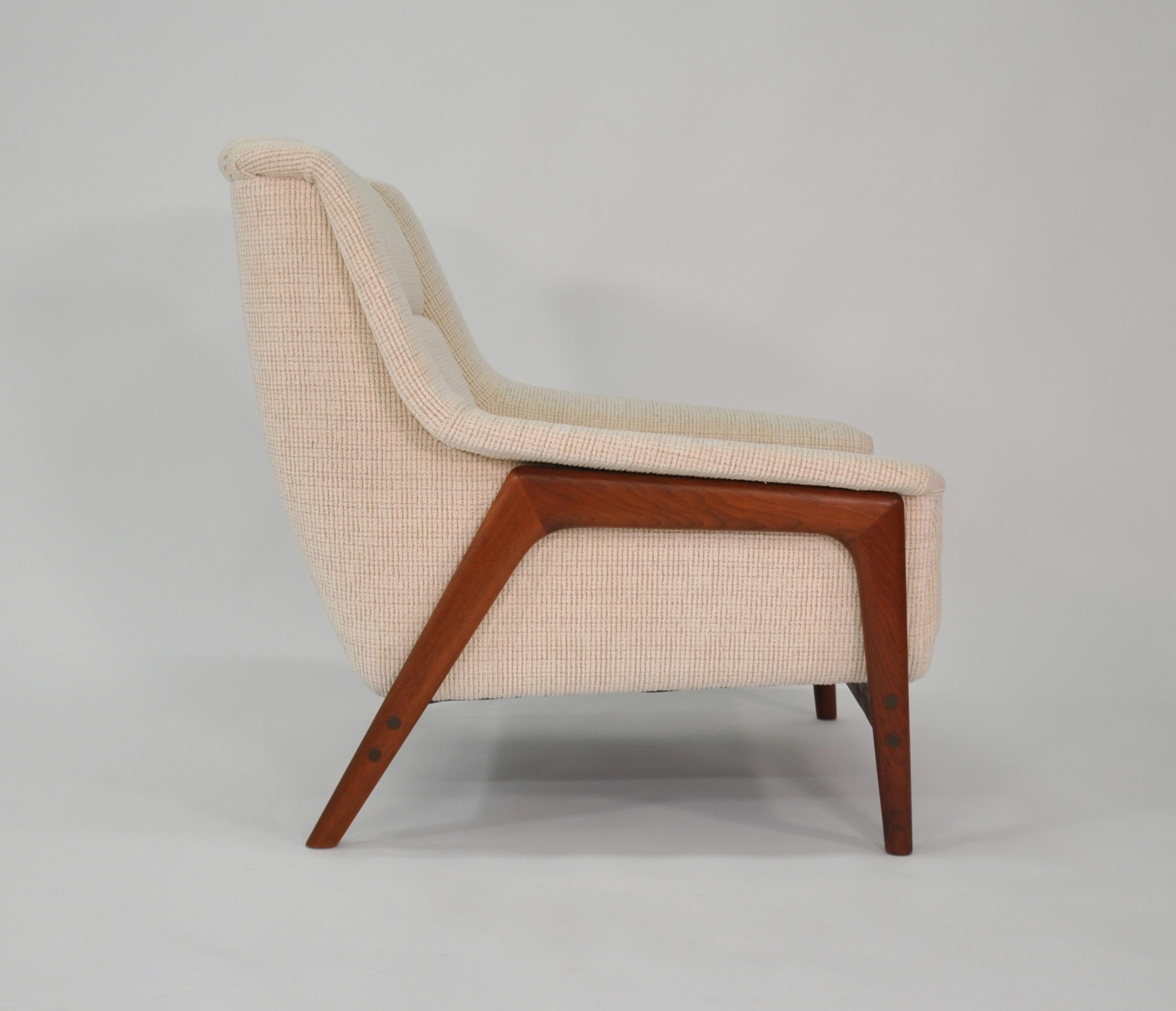 Beautiful newly reupholstered easy chair designed in the 1960s by Folke Ohlsson for Dux. The Profil armchair features an exposed sculptural solid teak frame. The club chair has been fully reupholstered in a soft, neutral off-white cream chenille.