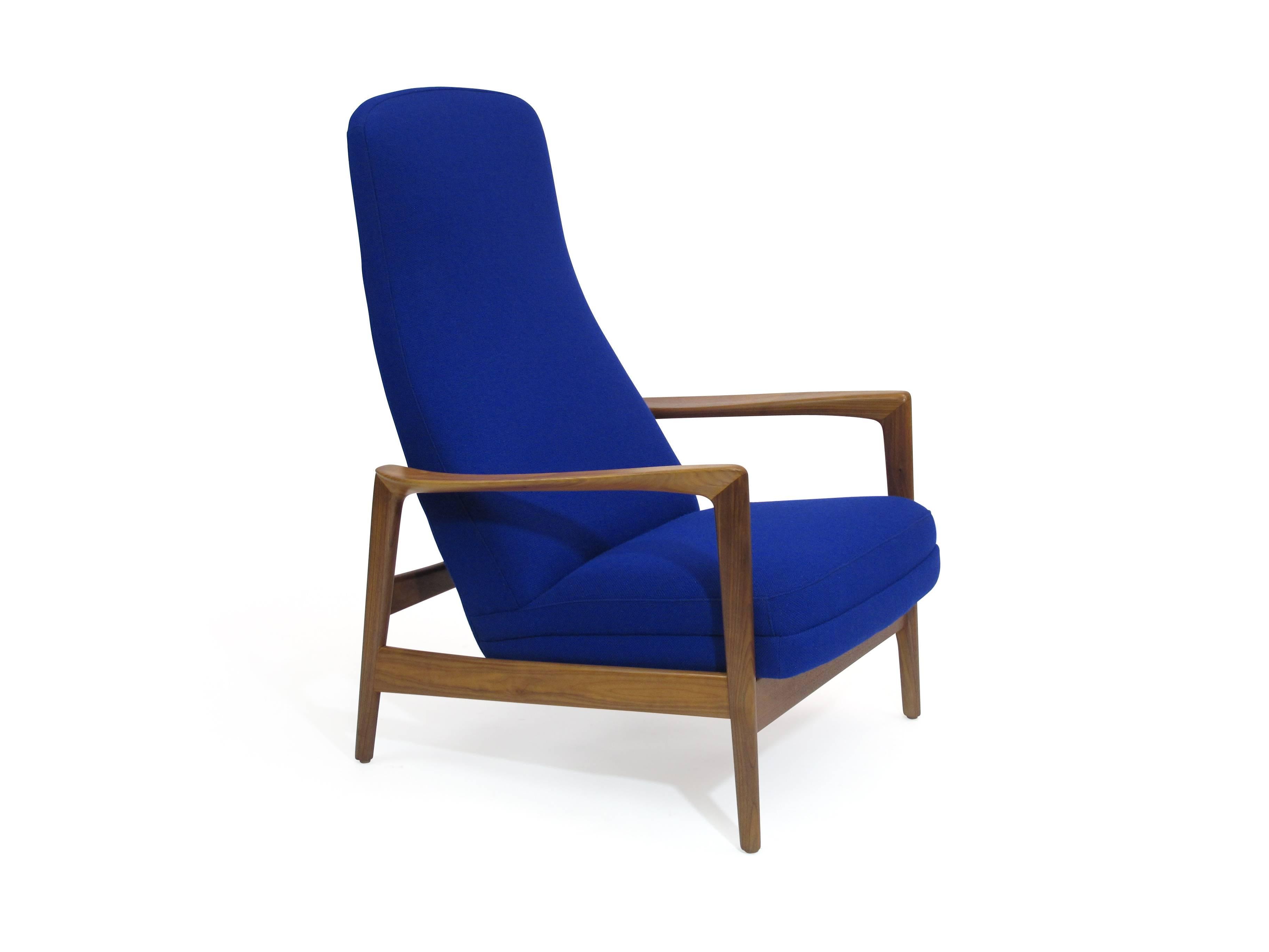 Midcentury walnut lounge chair designed by Folke Ohlsson for DUX. 
Solid walnut frame newly reupholstered with new foam covered in a bright cobalt blue wool fabric. Very comfortable reading chair with rocking motion with adjustable head pillow and