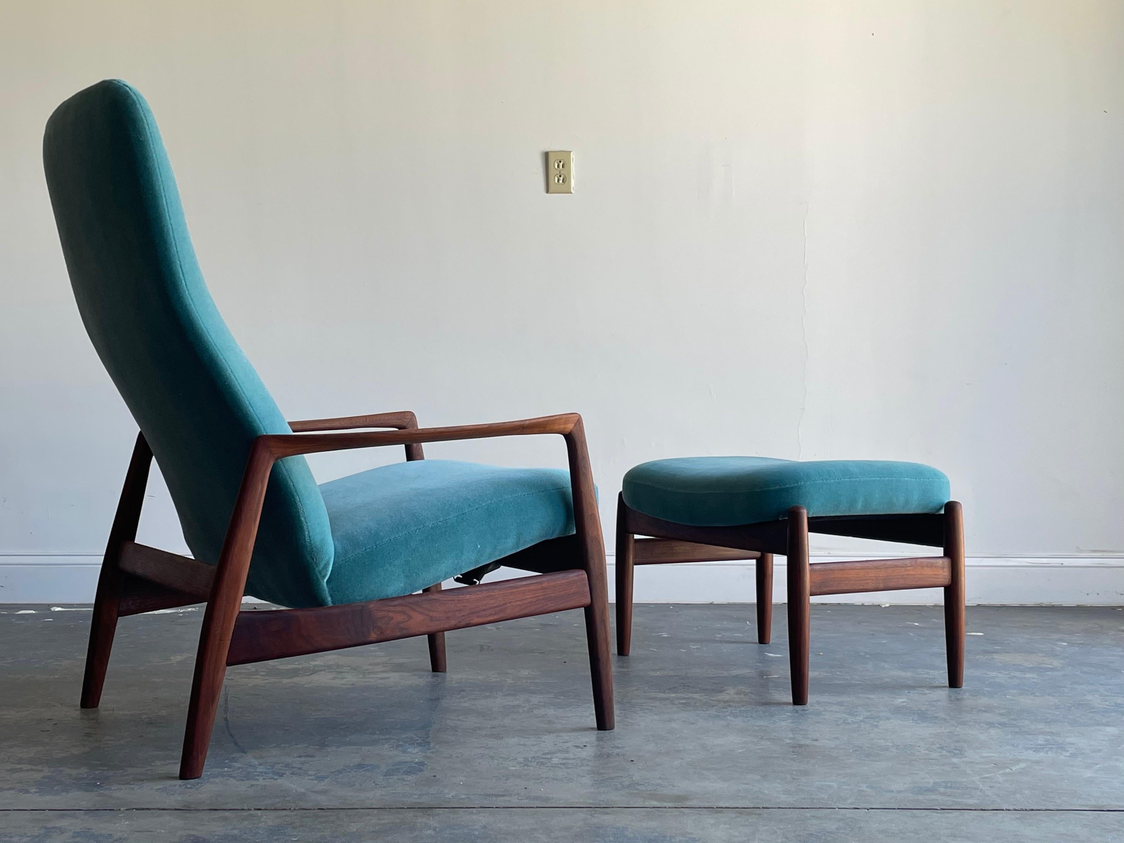 An elegant high back lounge chair designed by Folks Ohlsson for DUX. Executed in walnut and Mohair. Chair was been refinished and reupholstered. 

Chair 
40