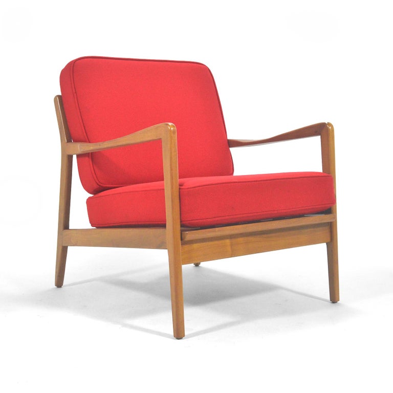 Classic Scandinavian Modern by the founder of DUX in the United States– Folke Ohlsson. This lovely lounge chair has a beech frame with sculpted arms that supports loose cushions newly upholstered in bright red fabric by Maharam.