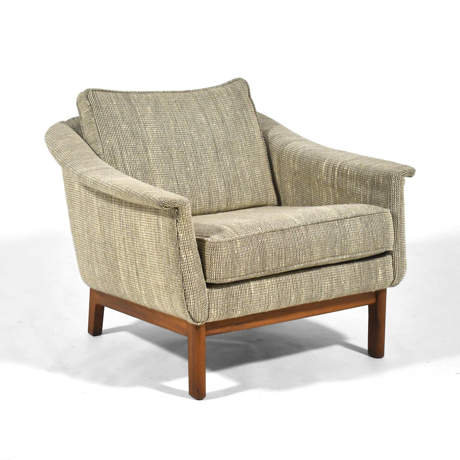 A beautiful, subtle design by Swedish designer Folke Ohlsson, this  upholstered lounge chair with gently curved lines is supported by a walnut base. In very good original vintage condition, it retains the original woven wool upholstery.

Also
