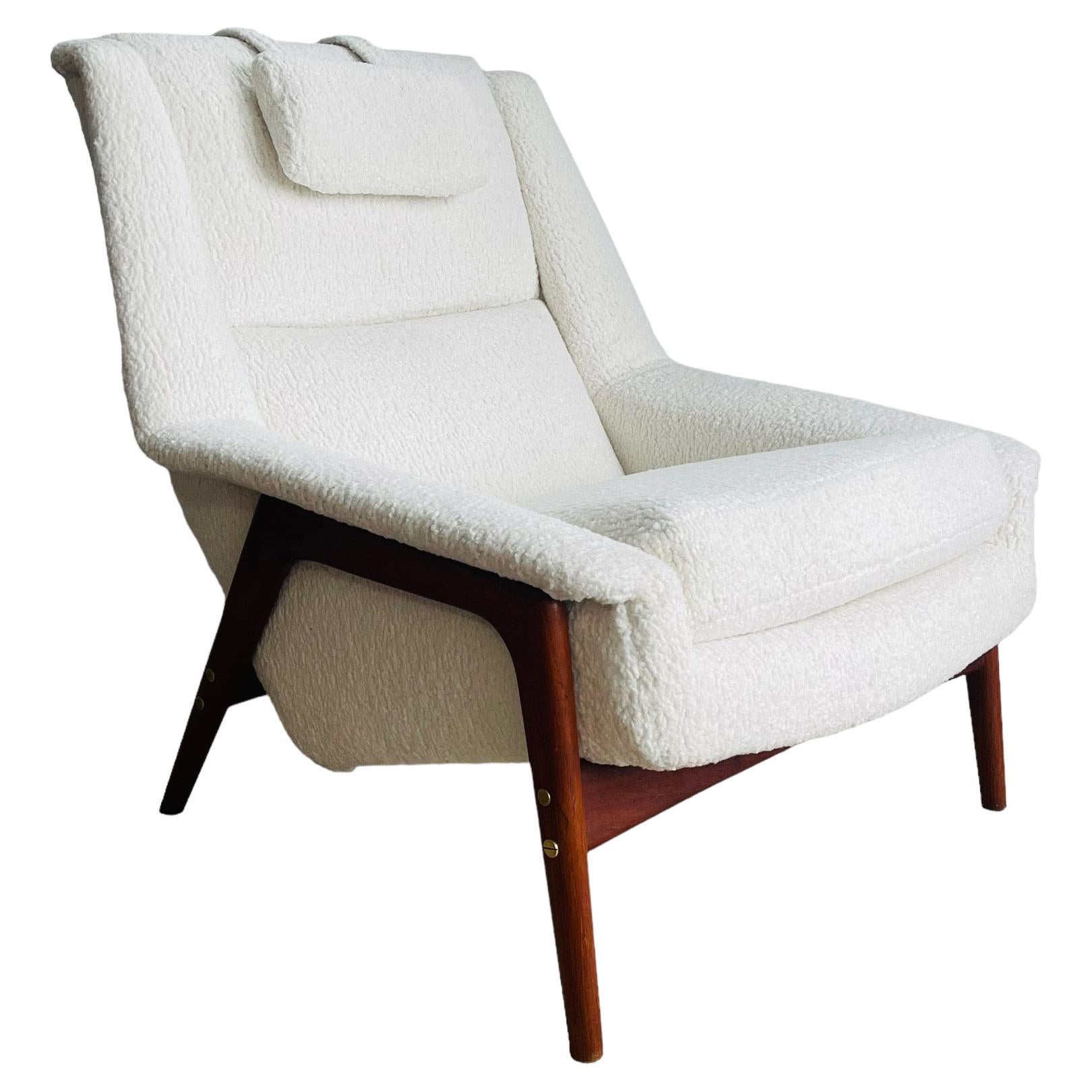 Stunning Mid-Century Modern lounge chair designed by Folke Ohlsson for DUX. This beautiful chair has been fully reupholstered and reupholstered in a sheepskin bouclé fabric. The chair has a sleek walnut frame with adjustable pillow and would be a
